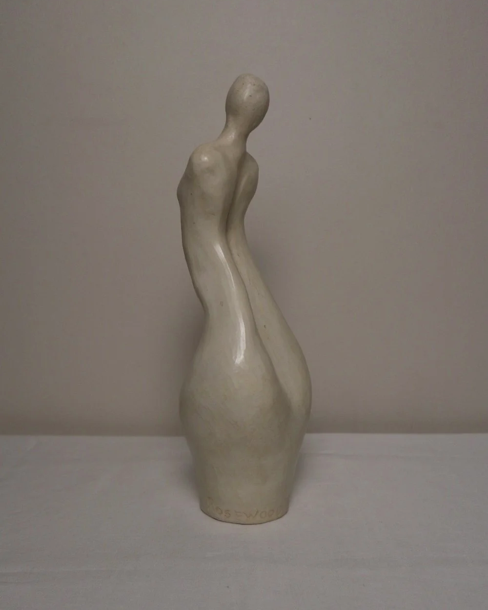 Set of three white ceramic abstract sculptures in the shape of the female form. Unknown age.  Signed 'R W Art / RoseWood Art'