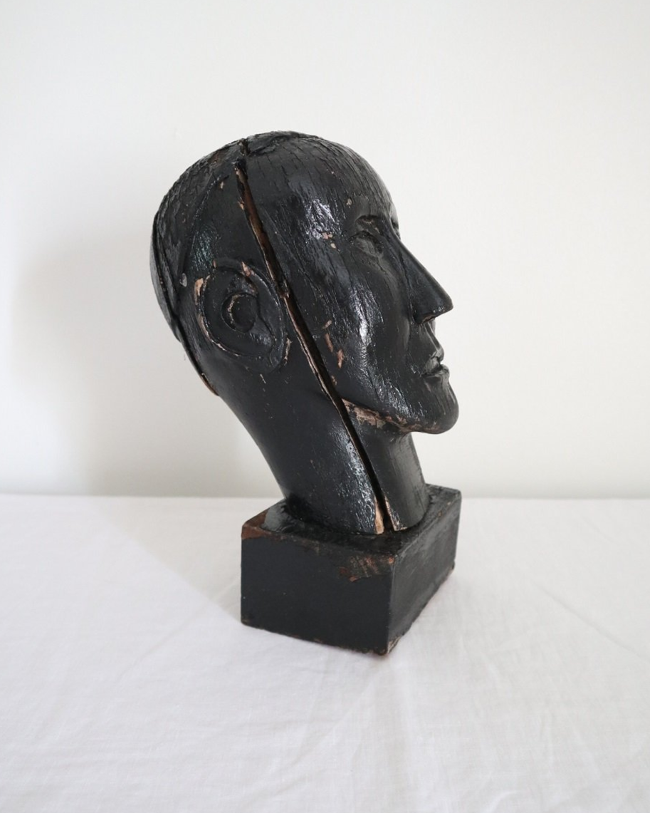 Vintage hand carved black painted wooden sculpture of male head. Age unknown.