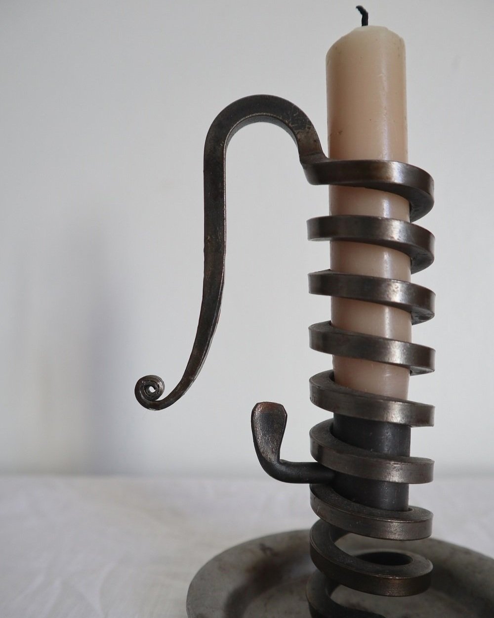 Vintage French 'Rat de cave' iron candleholder with turning spiral mechanism and signature curled handle. Circa 1970s. Marked 'Bourgogne Bouillot 71220 France'.