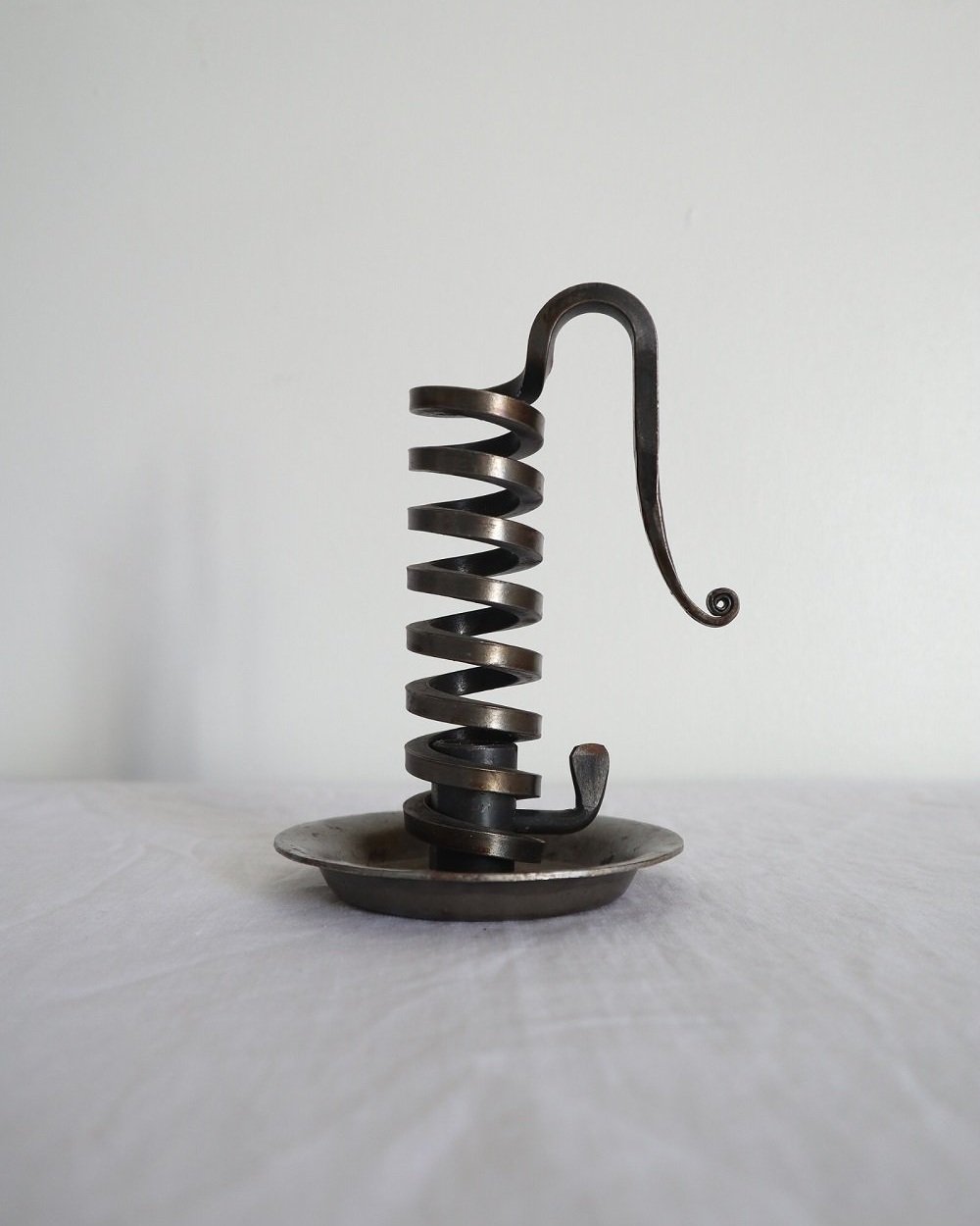 Vintage French 'Rat de cave' iron candleholder with turning spiral mechanism and signature curled handle. Circa 1970s. Marked 'Bourgogne Bouillot 71220 France'.