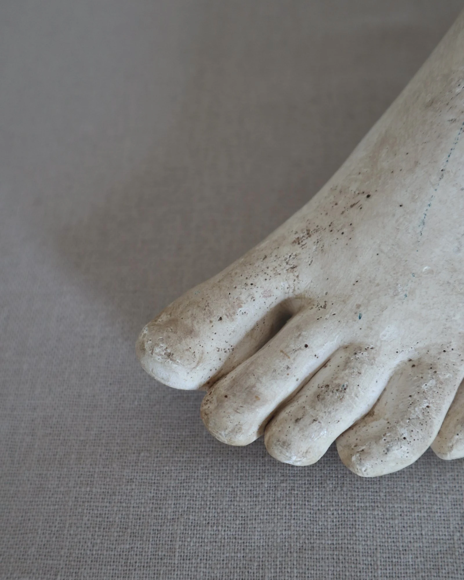 Classical-style decorative plaster foot sculpture, likely used as an anatomical or art studio study model.