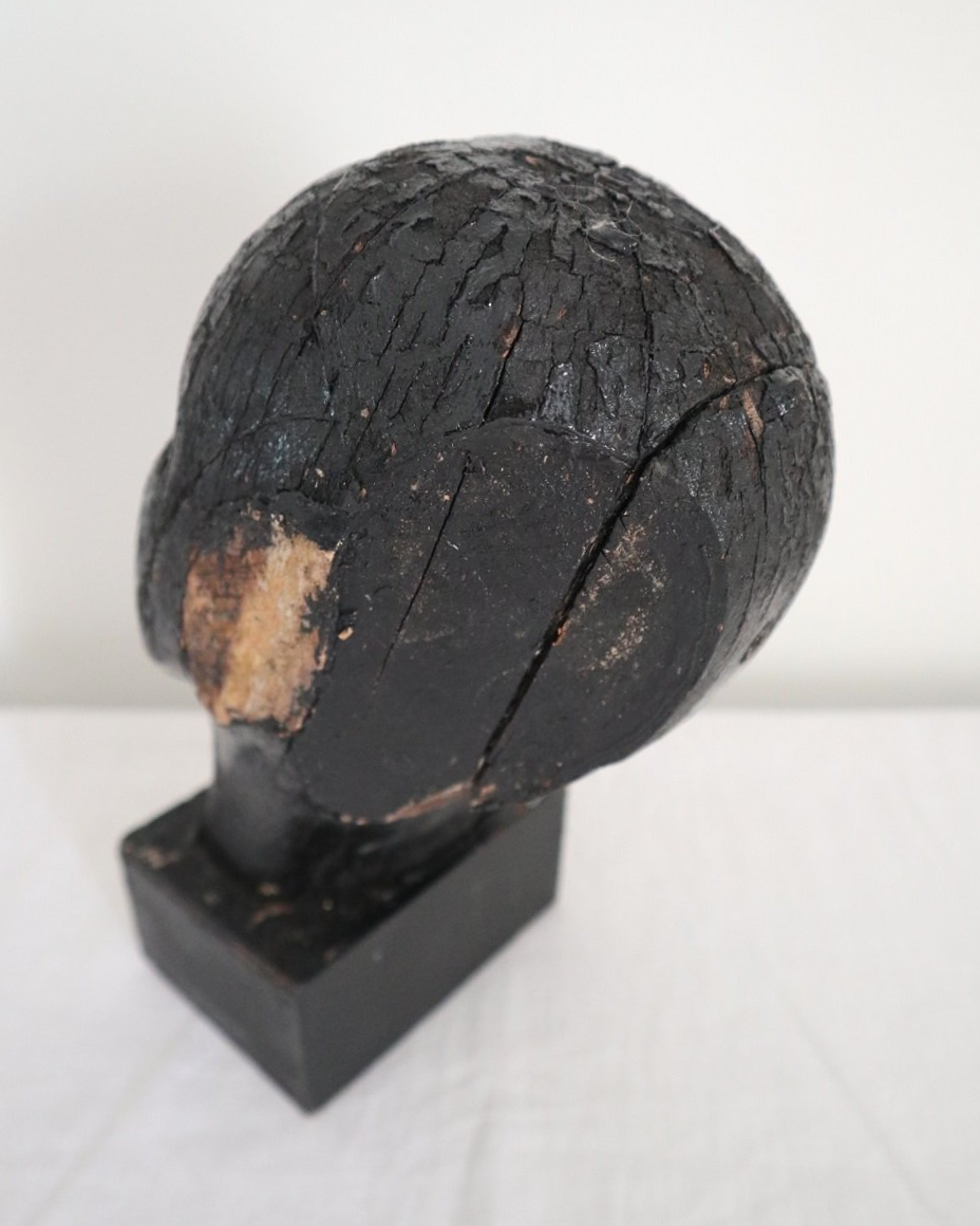 Vintage hand carved black painted wooden sculpture of male head. Age unknown.