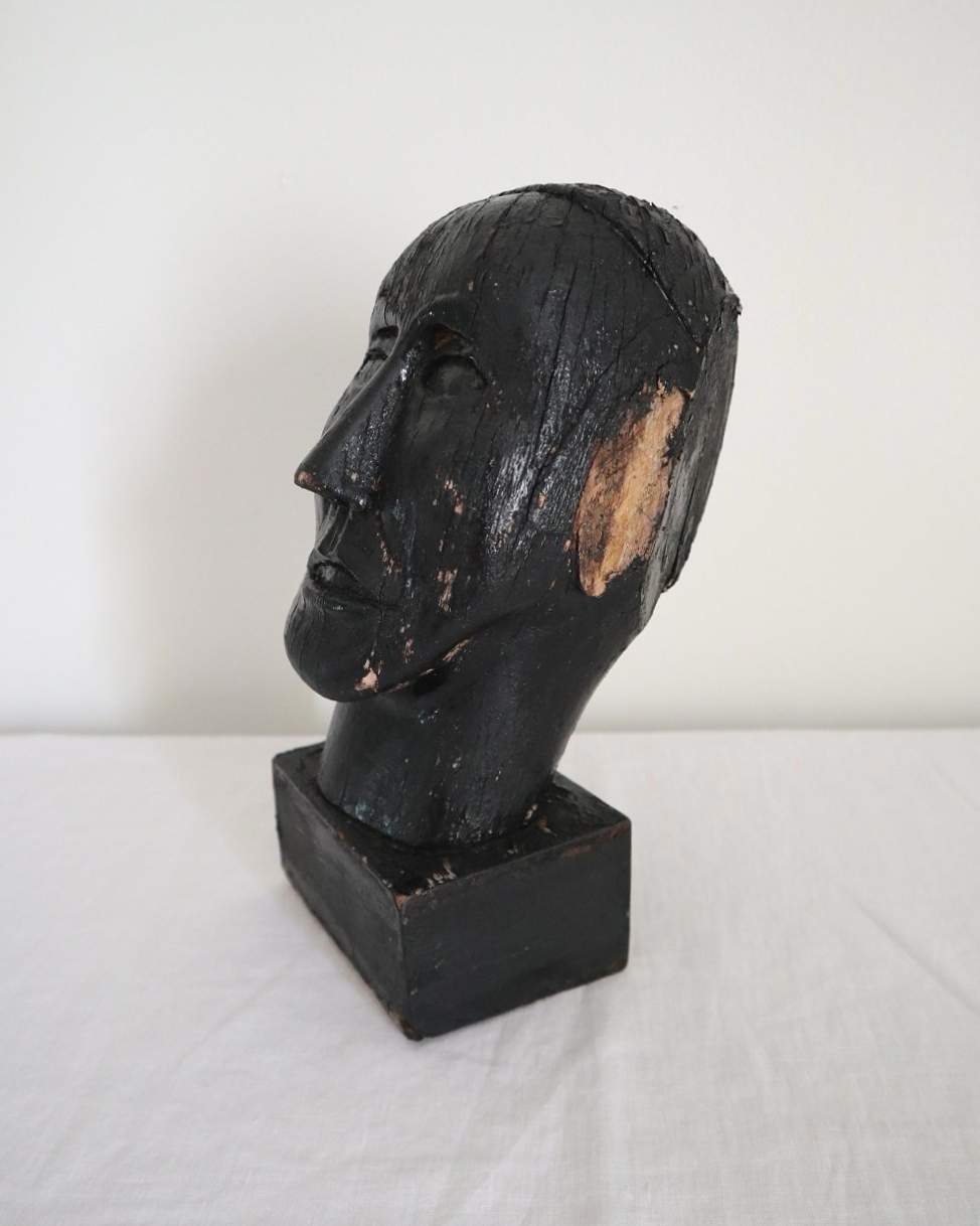 Vintage hand carved black painted wooden sculpture of male head. Age unknown.