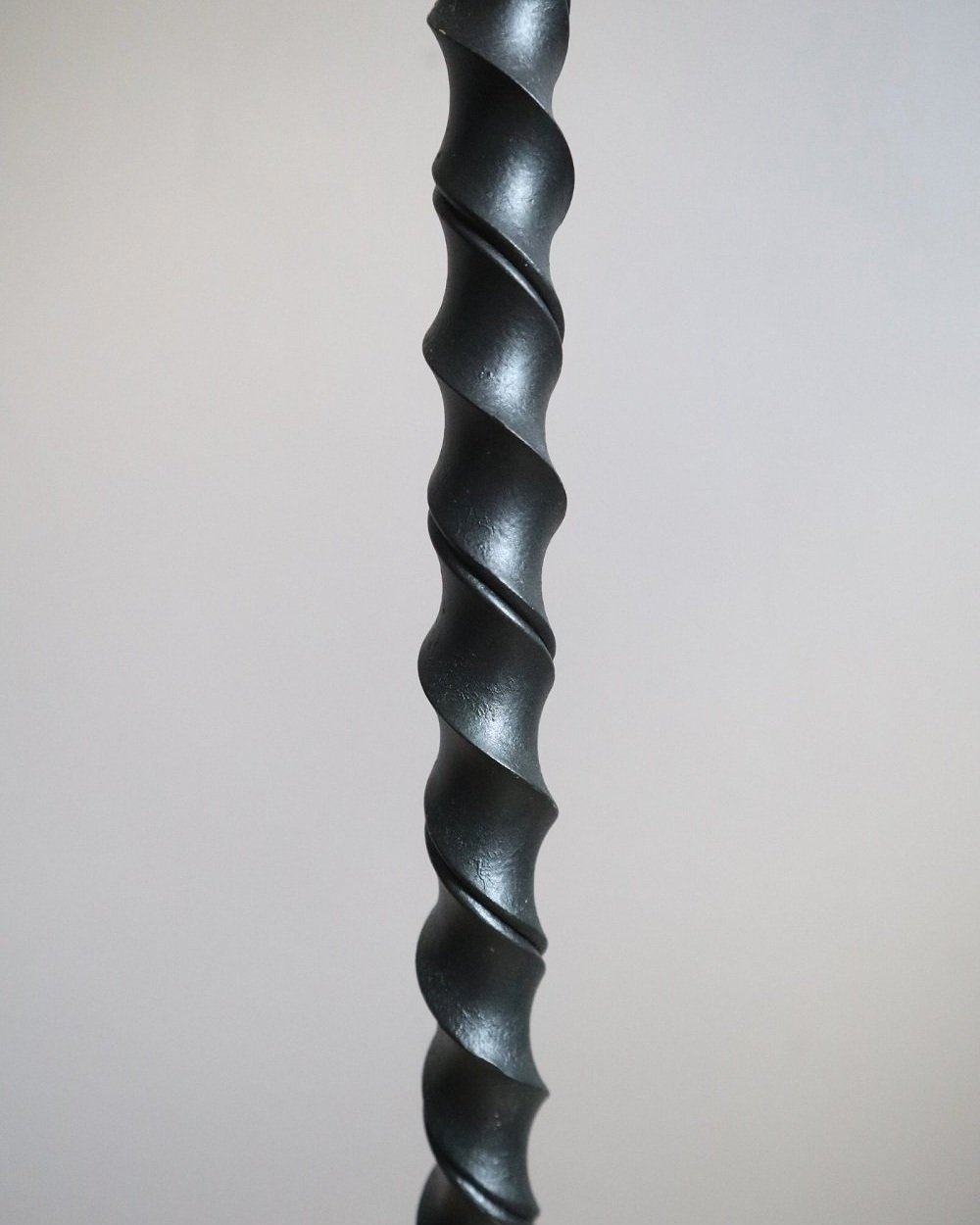 French wrought iron floor lamp with twisted corkscrew column and tripod base. Circa 1950s.