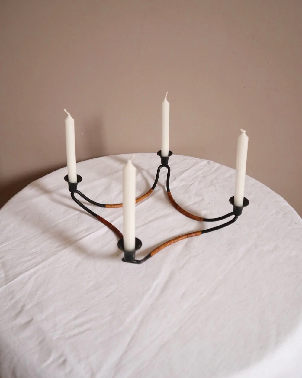 Modernist Danish iron and woven rattan four candle holder designed by Laurids Lønborg. Circa 1950s.