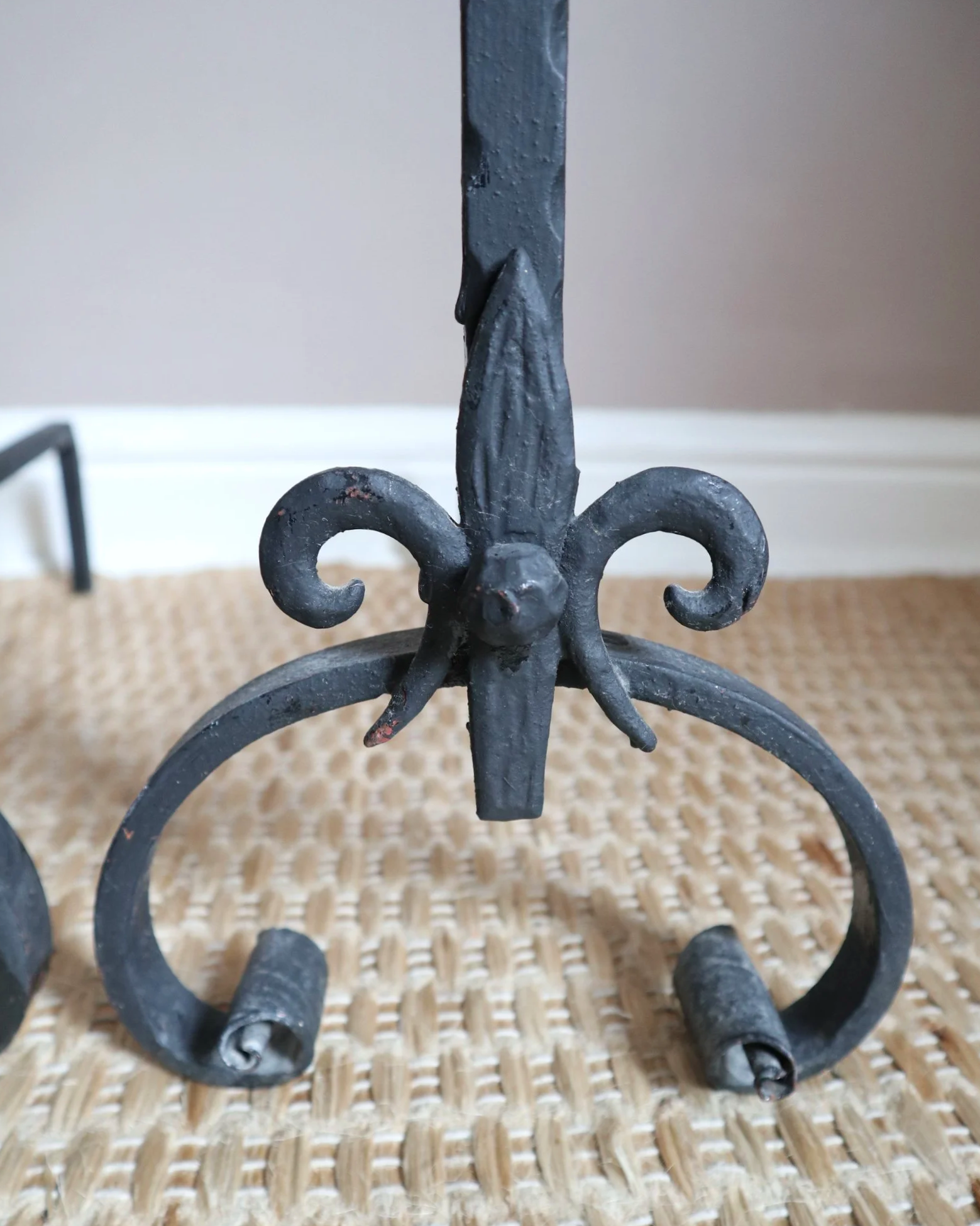 Pair of black wrought-iron andirons or firedogs featuring stylized rooster finials, circa mid-20th century.