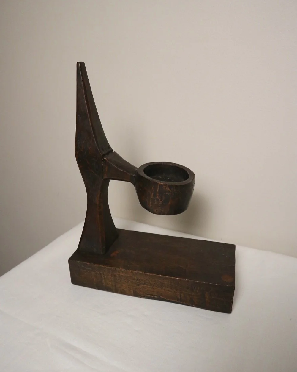 American hand carved dark wooden Brutalist candleholder with block base.