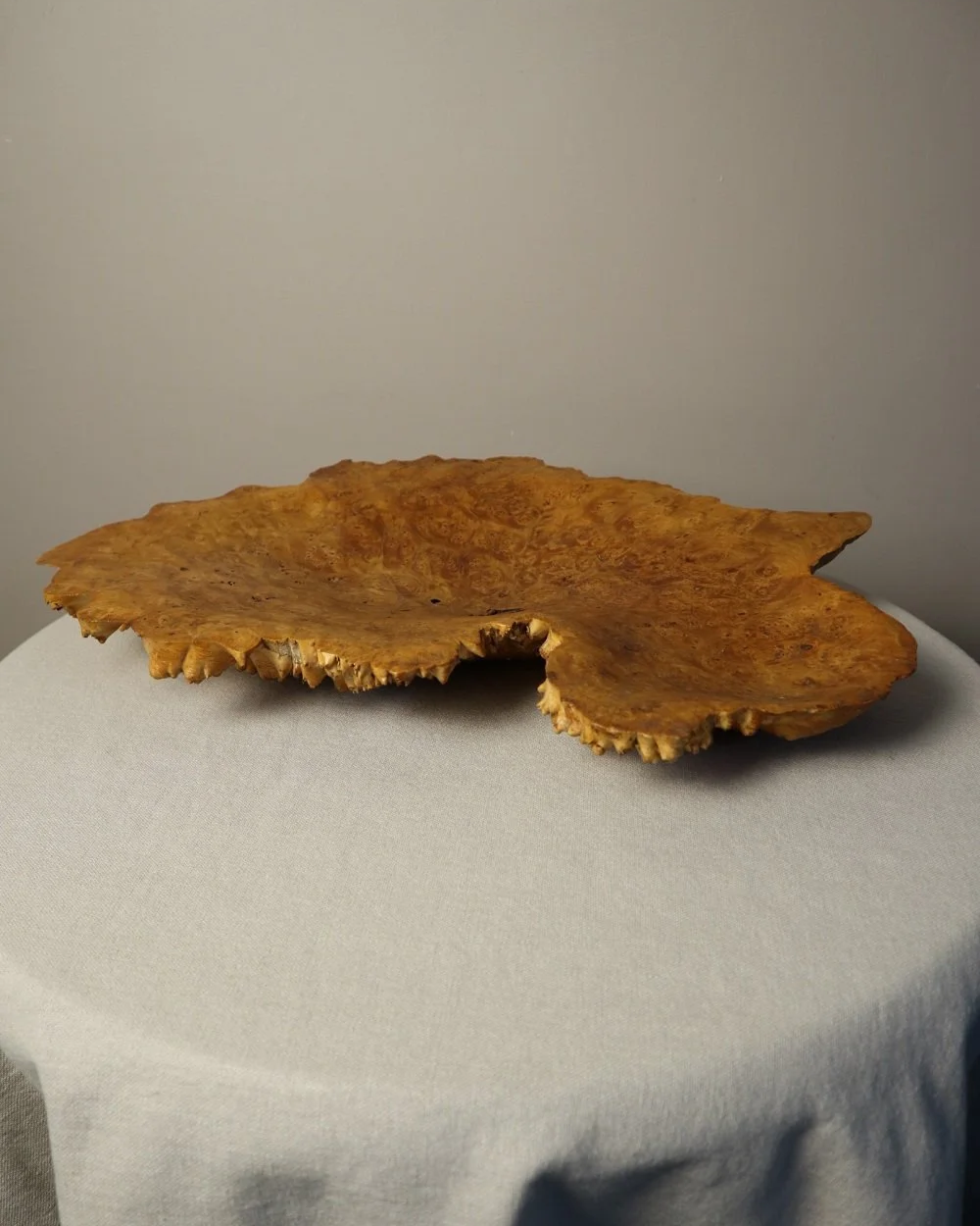 Decorative hand carved golden toned burr wood centrepiece dish with polished centre and organic naturalistic outside.