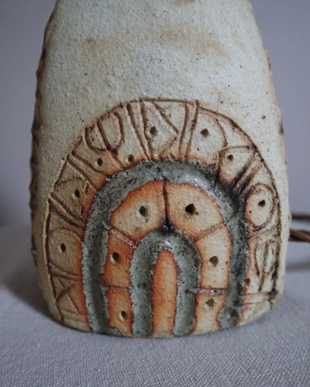 Small Brutalist stoneware table lamp by British potter Bernard Rooke. With stamped, rune-like impressions. Circa 1970s.