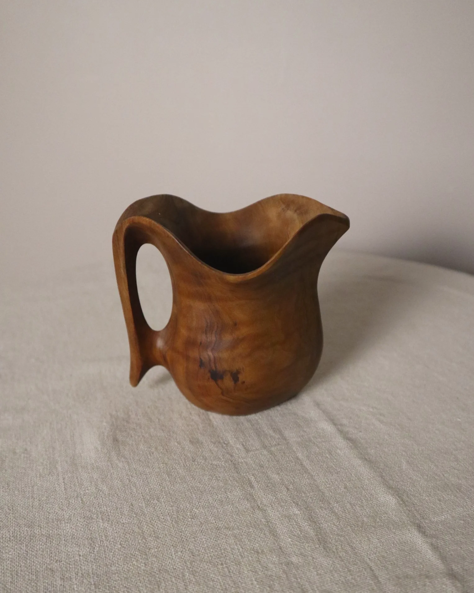 Small mid century hand carved sculptural olivewood jug in the style of Alexandre Noll. Circa 1960s.