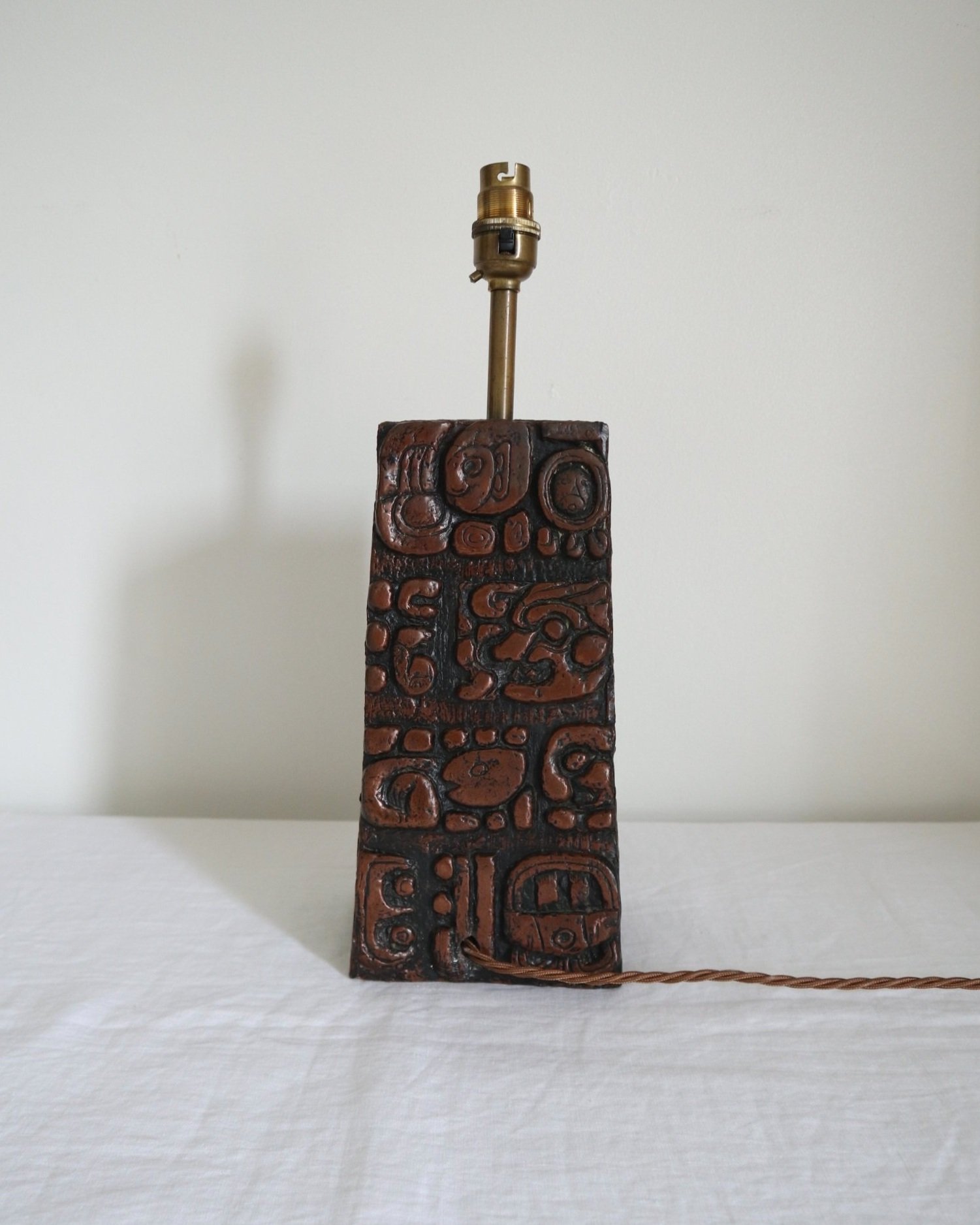 Mid century very heavy Brutalist Aztec style cast resin table lamp with metallic bronze finish.