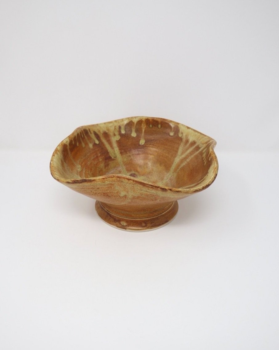 tage, handmade studio pottery ceramic bowl with wavy edge and brown, orange and ochre glaze. Marked Baughan 1997 to base.