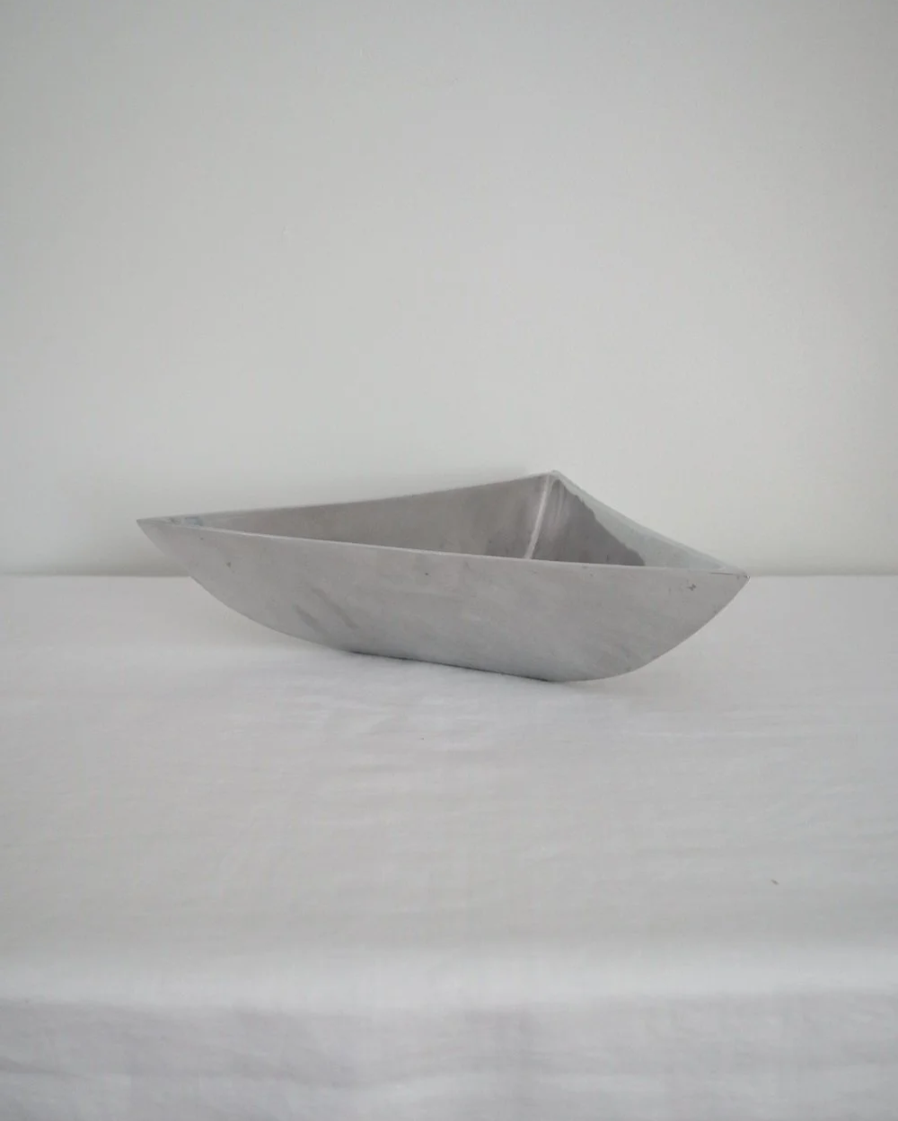 Solid shiny aluminium triangular Modernist style dish.