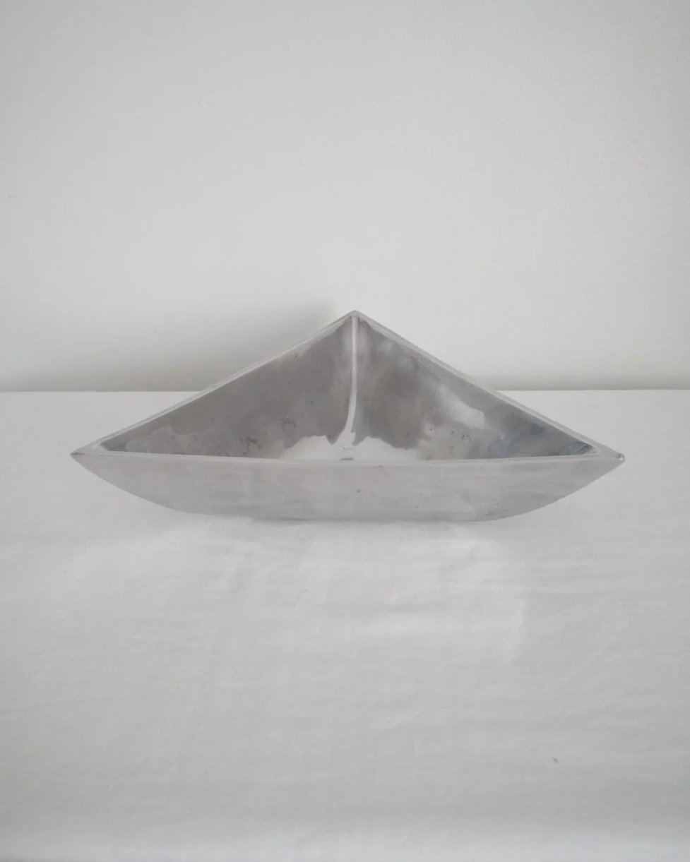 Solid shiny aluminium triangular Modernist style dish.