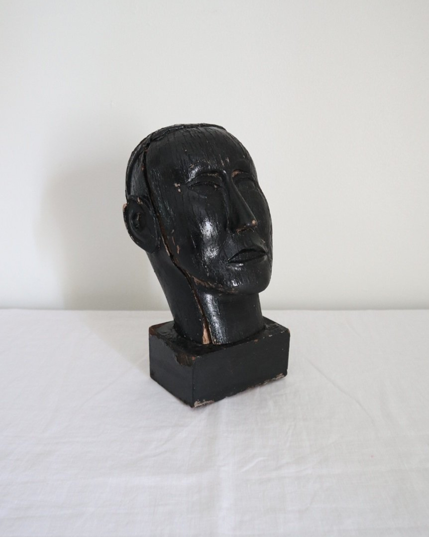 Vintage hand carved black painted wooden sculpture of male head. Age unknown.