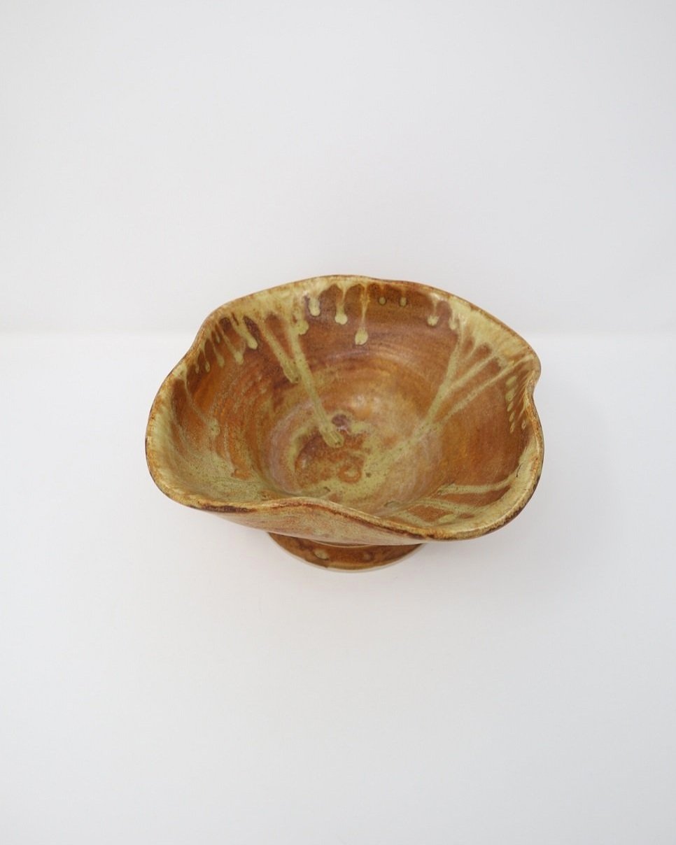 tage, handmade studio pottery ceramic bowl with wavy edge and brown, orange and ochre glaze. Marked Baughan 1997 to base.