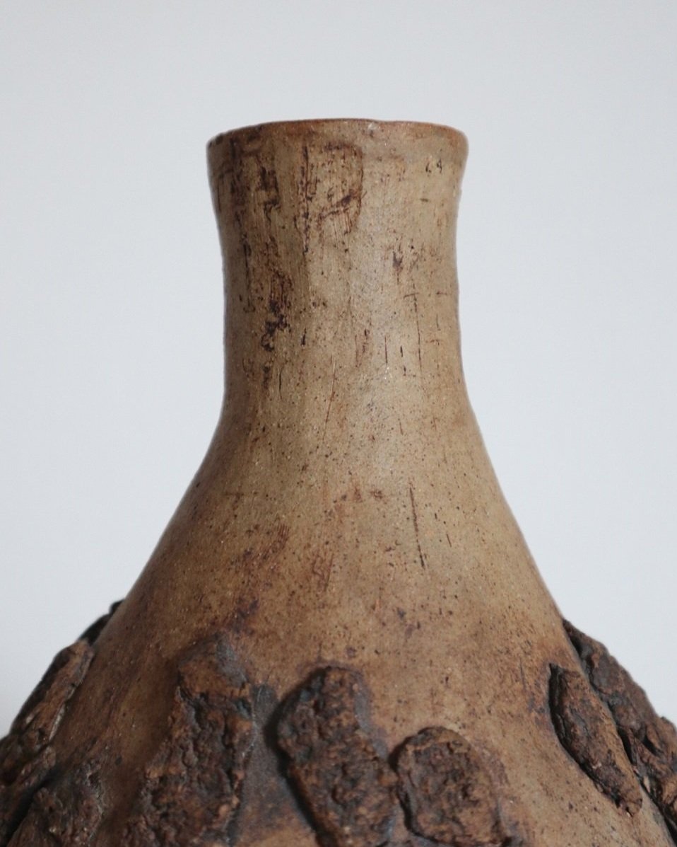Studio pottery brown ceramic decorative vase with textured, tree bark effect decorations and a tapered neck. Age unknown.