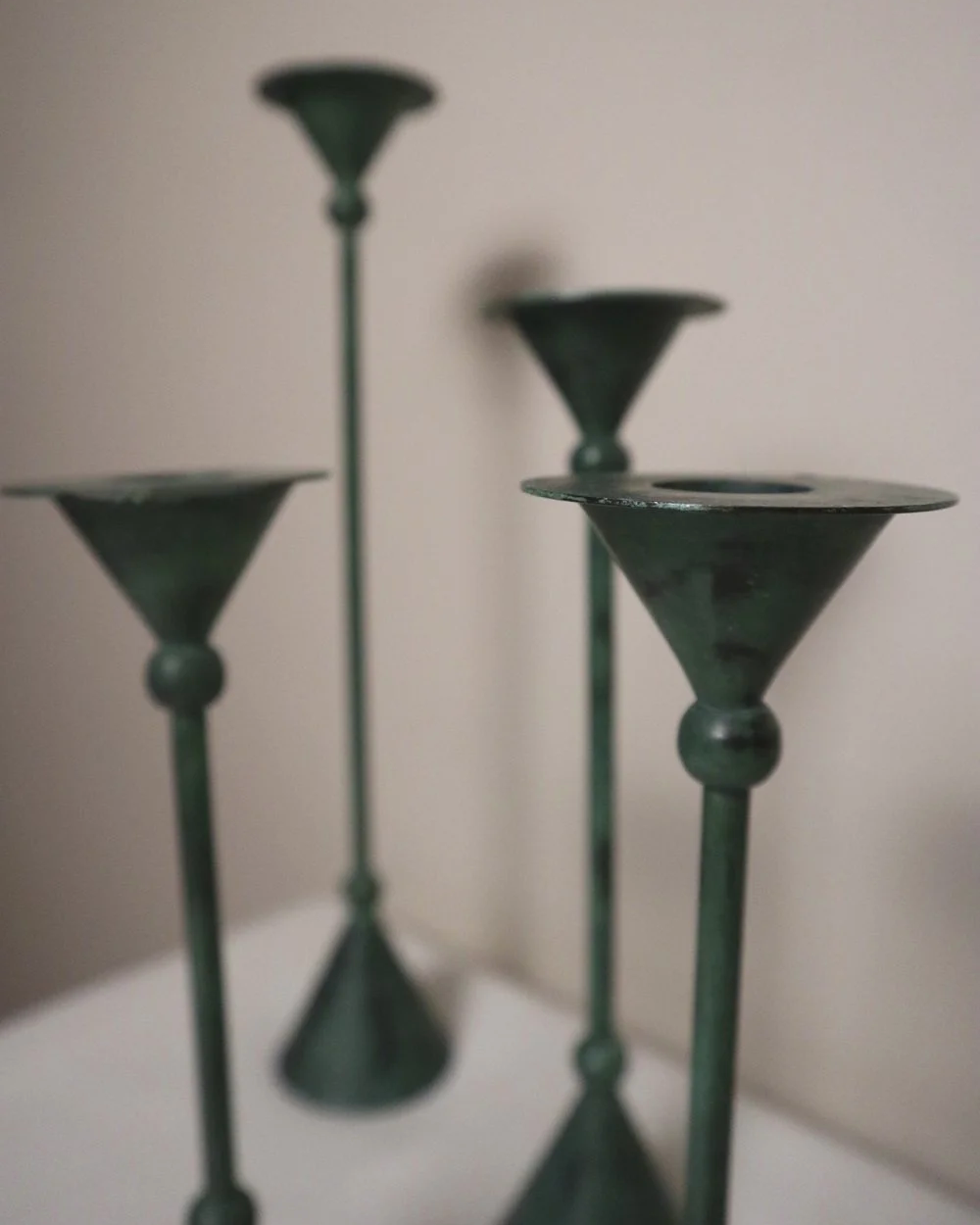 Set of 4 Postmodern verdigris metal candleholders, circa 1980s. In the Memphis style of Christian de Beaumont.