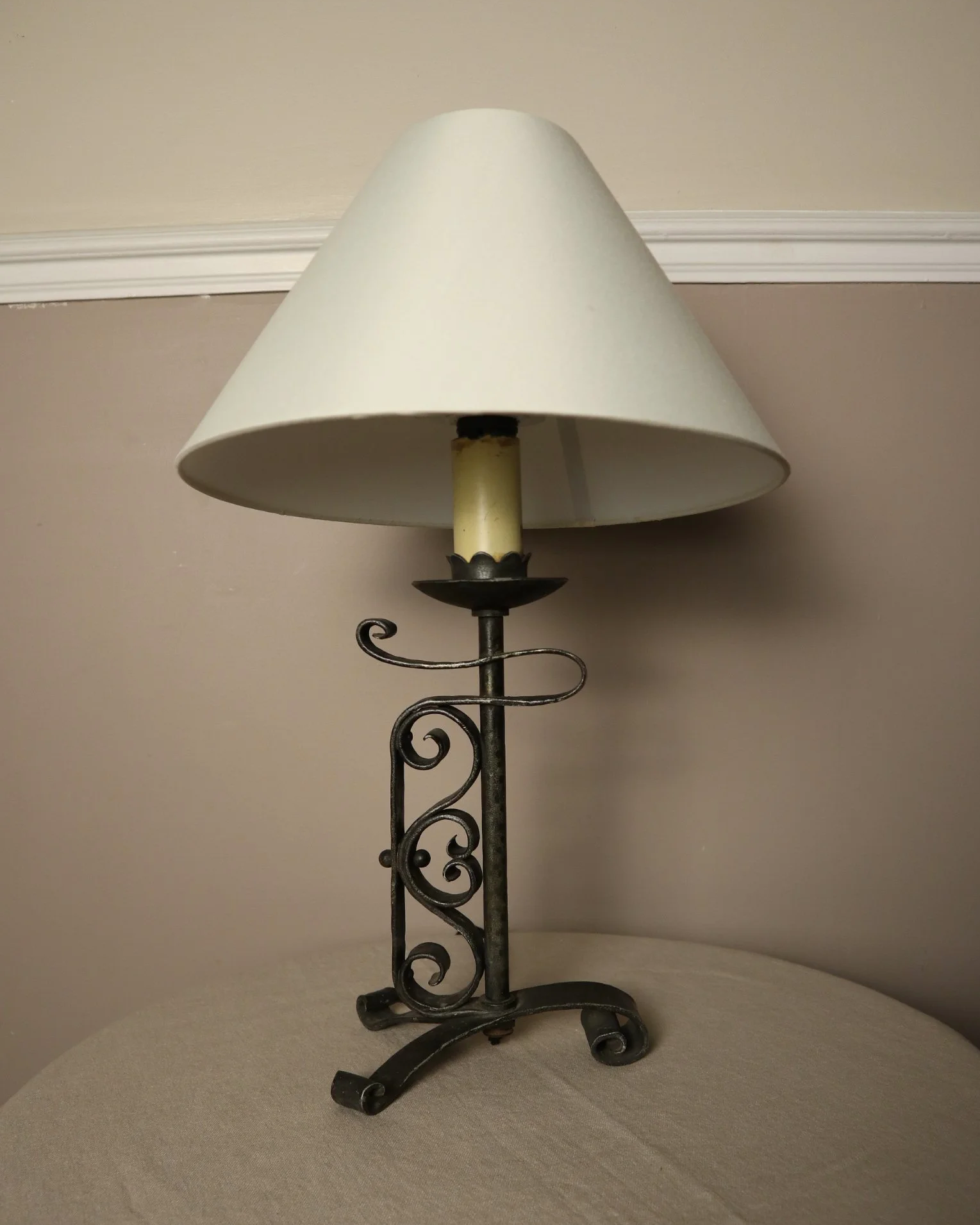 Vintage Art Deco style metal candlestick table lamp with elegant scroll detailing.