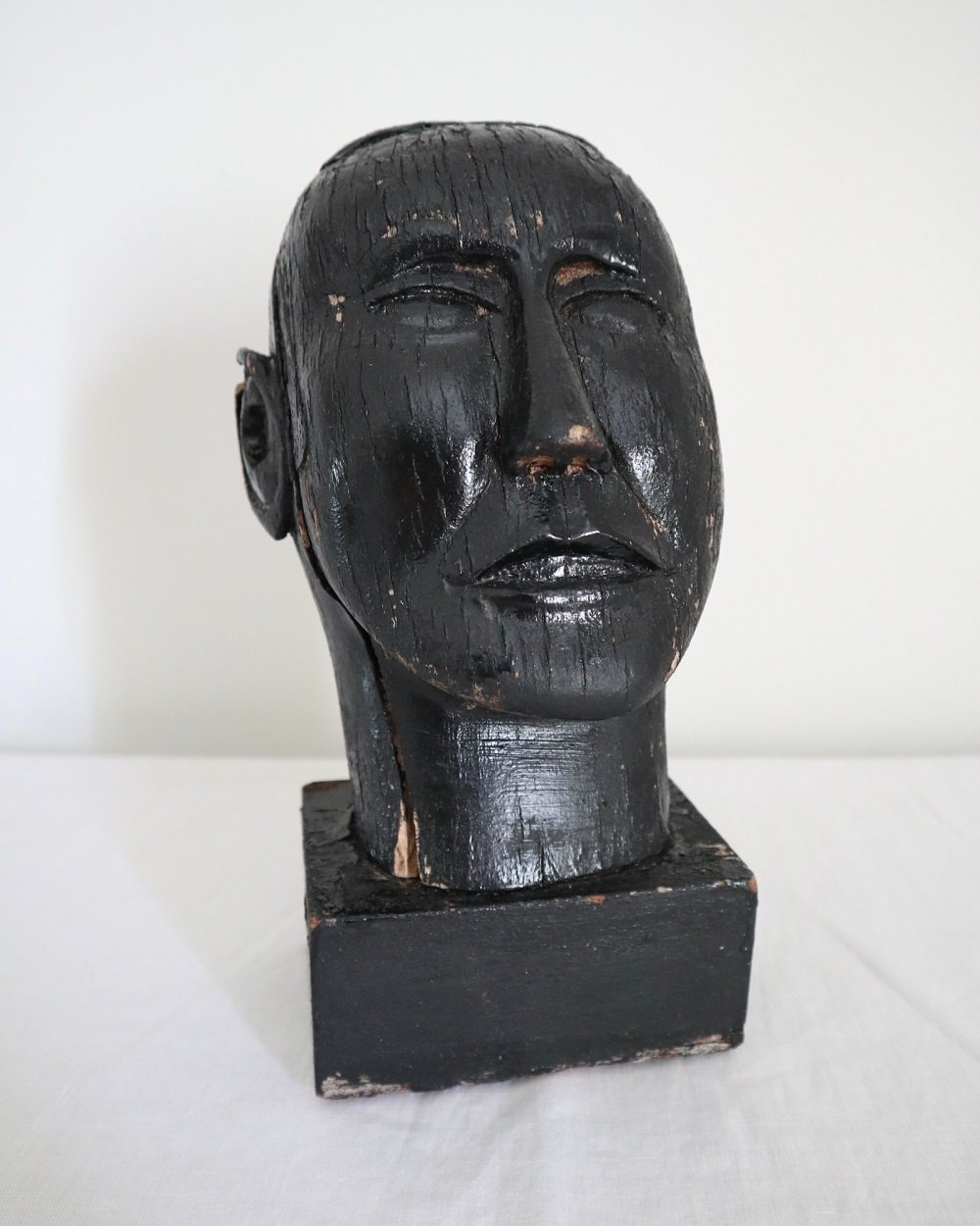 Vintage hand carved black painted wooden sculpture of male head. Age unknown.