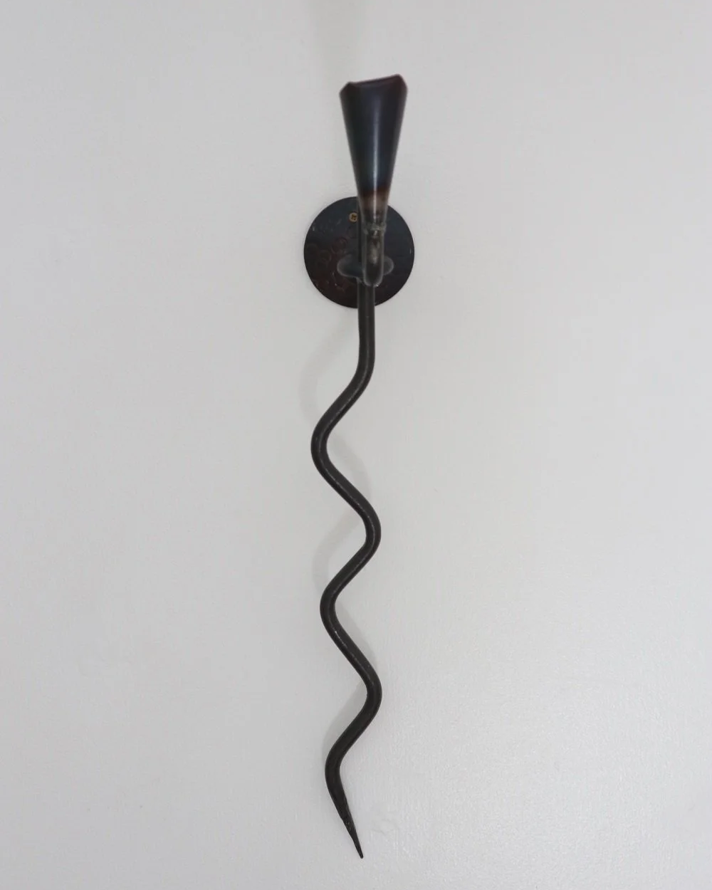 Large Swedish black iron wall sconce candleholder with wavy design. Circa 1960s.