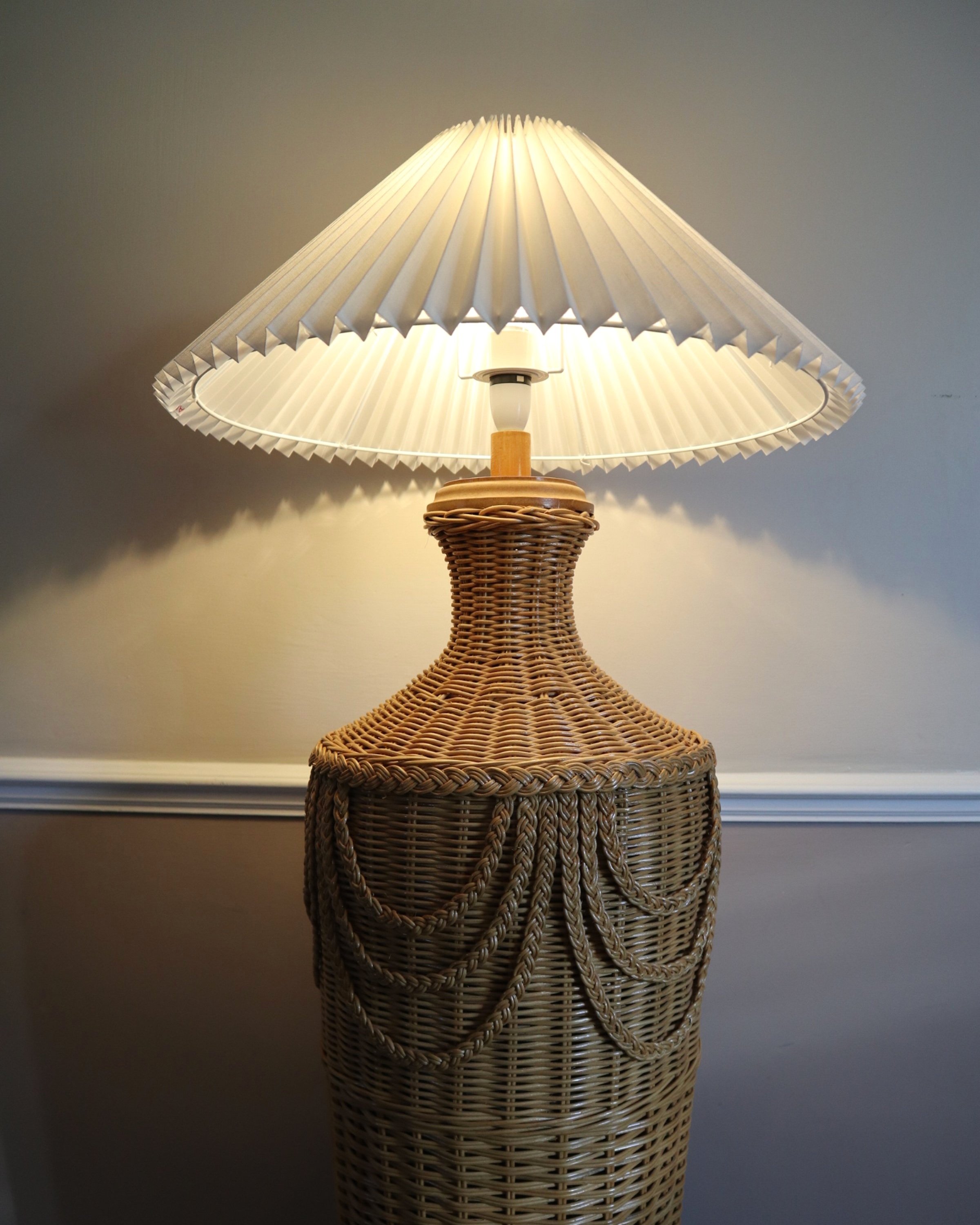 20th Century woven rattan floor lamp with Hollywood Regency style braided detailing.