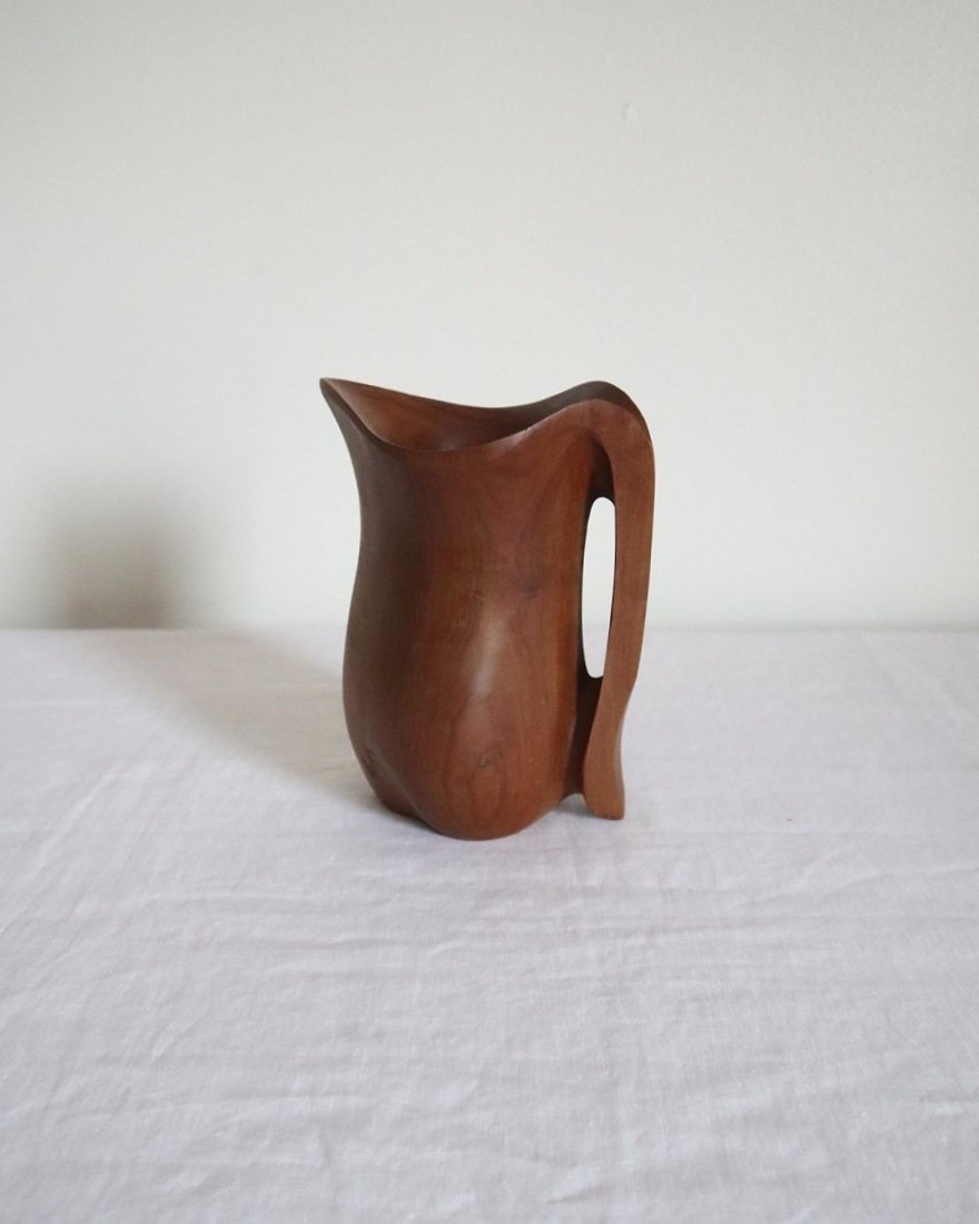 Small sculptural hand carved dark olivewood monoxyl pitcher, circa 1960/70s. In the manner of Alexandre Noll. Unsigned.