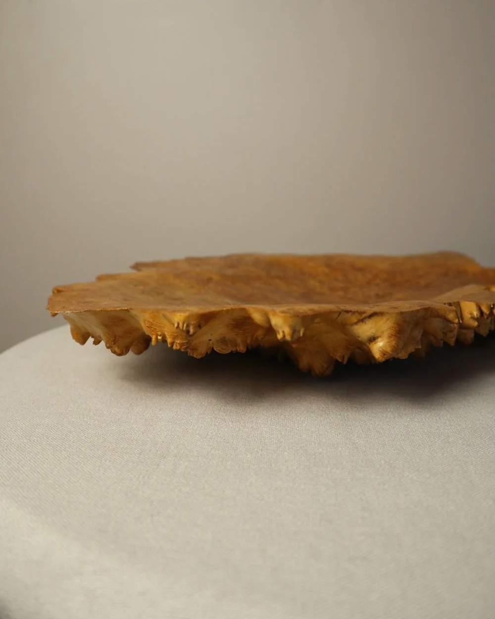 Decorative hand carved golden toned burr wood centrepiece dish with polished centre and organic naturalistic outside.