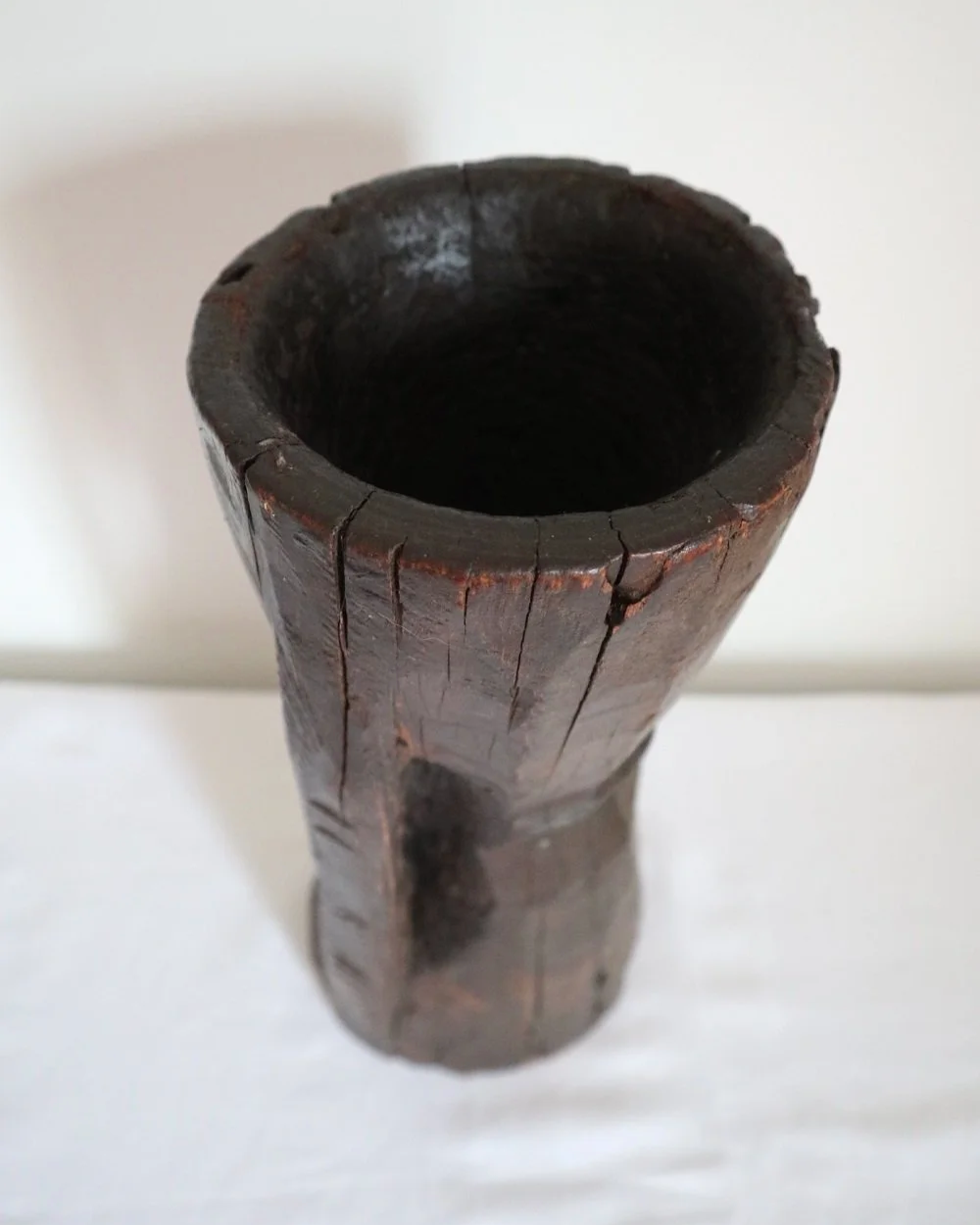 Heavy primitive sculptural carved wooden mortar with handle.