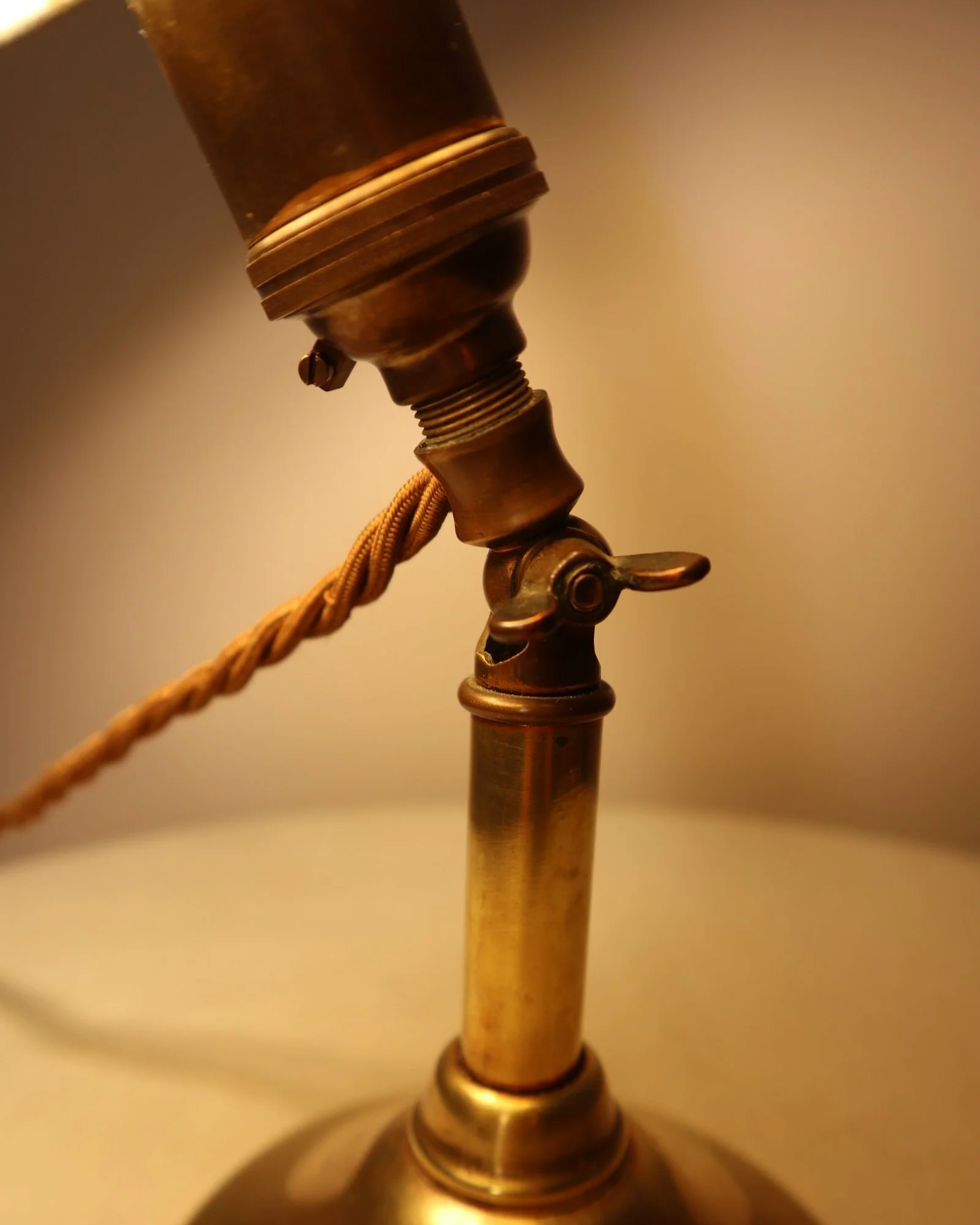 Small, vintage adjustable brass worker's desk lamp. Can be freestanding or attached to the edge of a workbench etc with clamp.