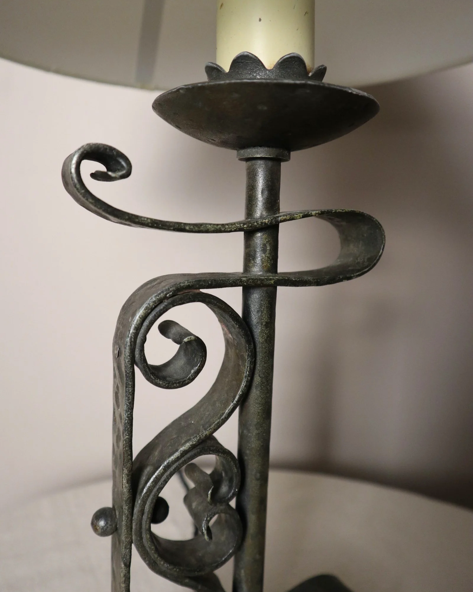 Vintage Art Deco style metal candlestick table lamp with elegant scroll detailing.