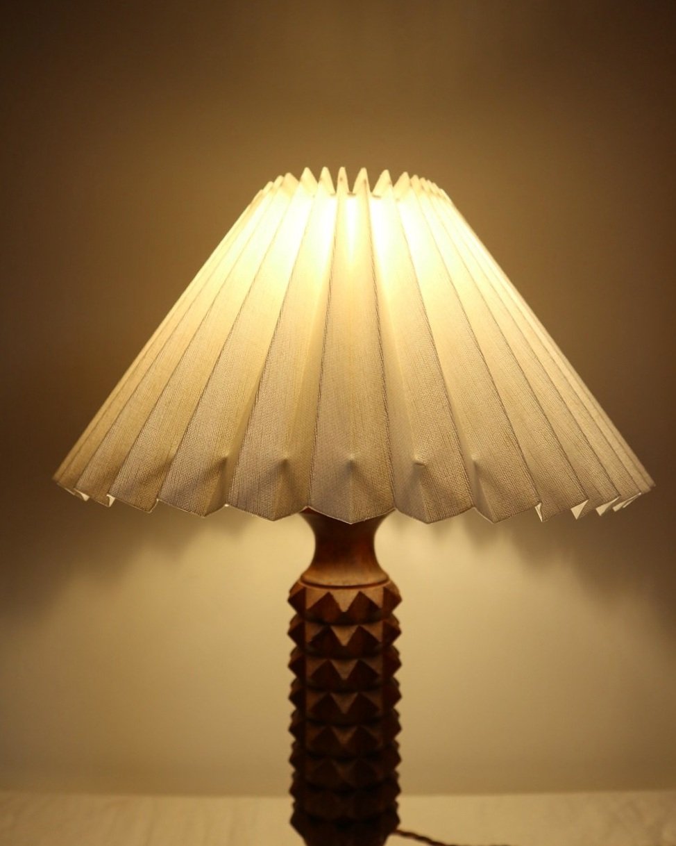French Charles Dudouyt style carved wooden Brutalist table lamp with new, white pleated lampshade.