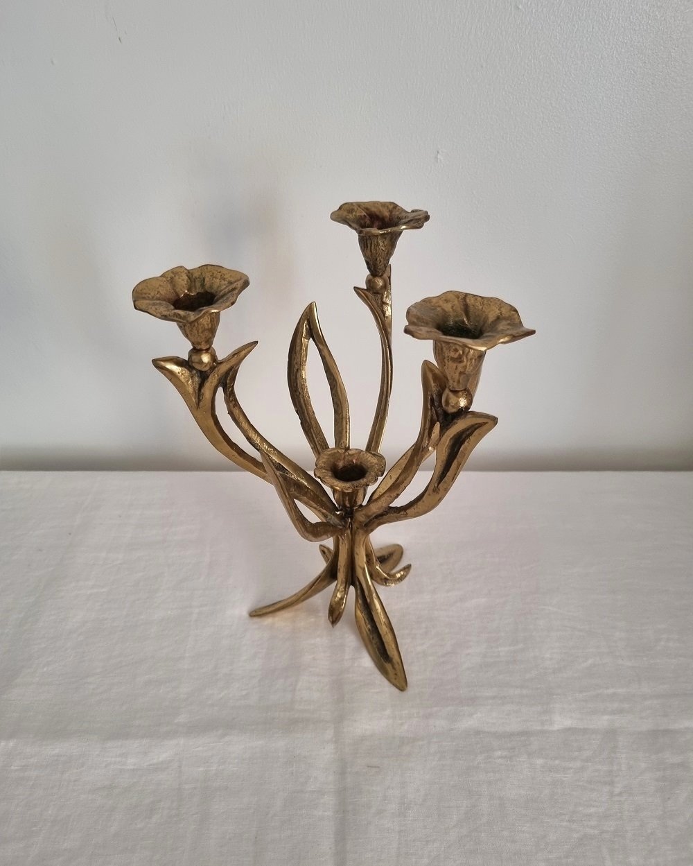 Mid century Art Nouveau style floral heavy brass candelabra with three arms and central candleholder. Circa 1970s.