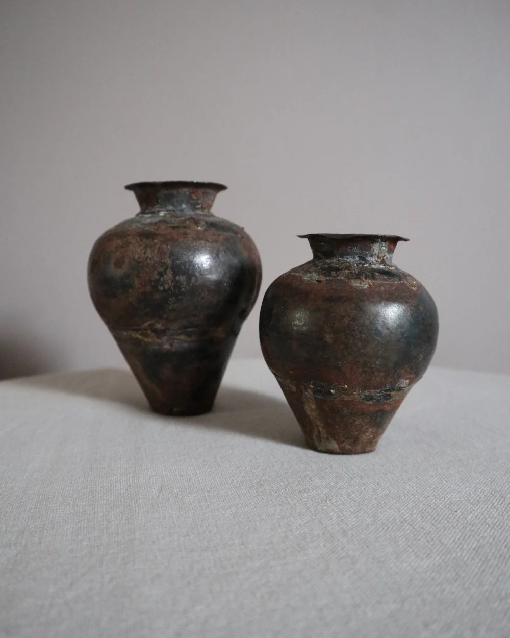 Set of two small metal vases