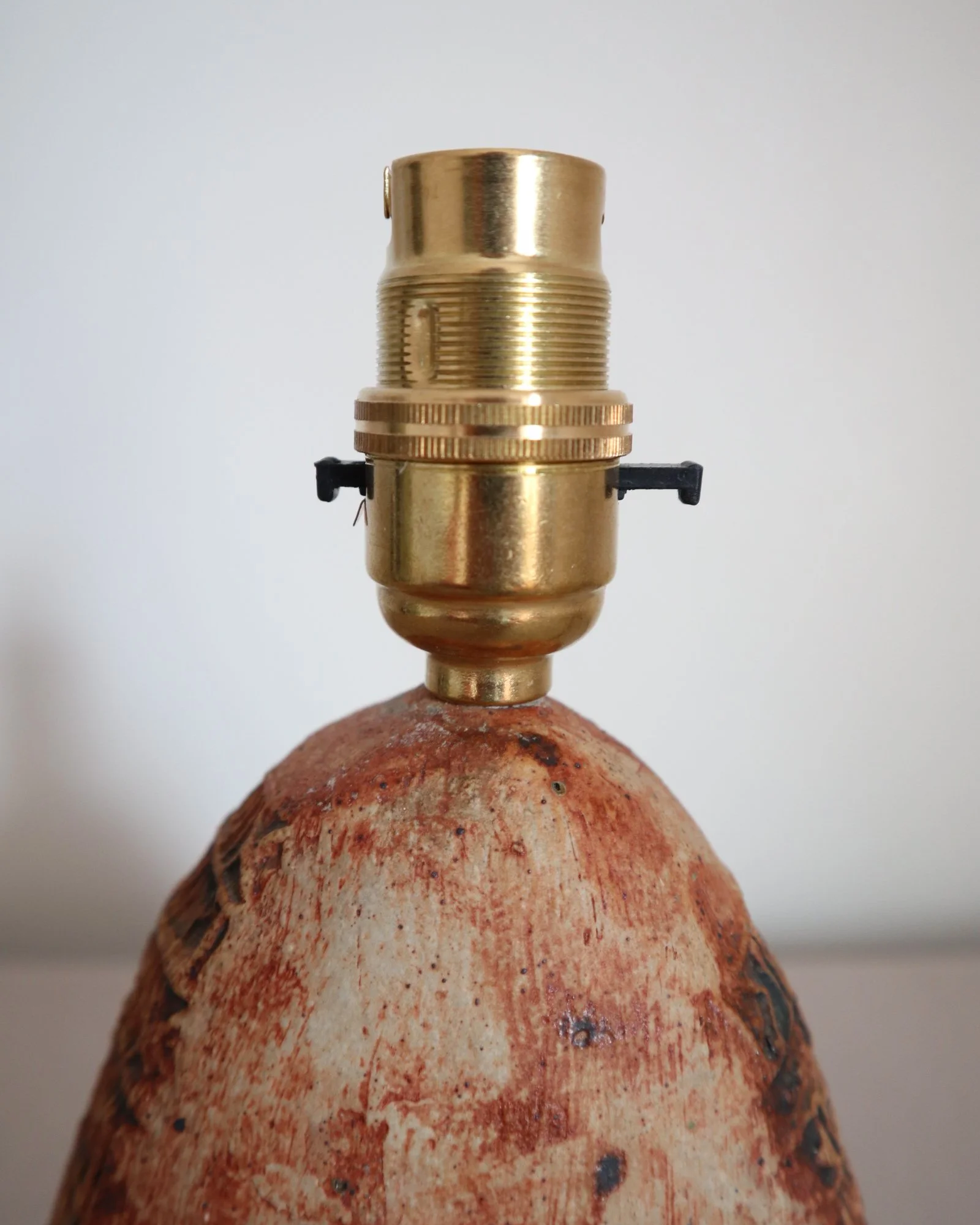 Small Brutalist stoneware table lamp by British potter Bernard Rooke. With stamped, rune-like impressions. Circa 1970s.