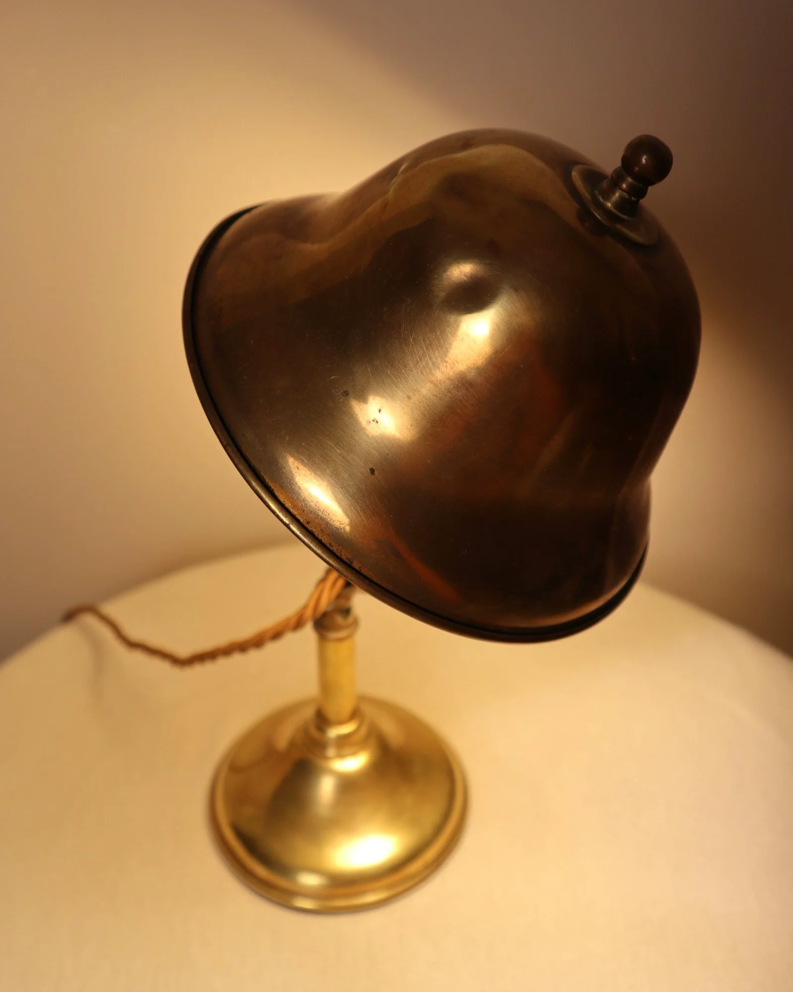 Small, vintage adjustable brass worker's desk lamp. Can be freestanding or attached to the edge of a workbench etc with clamp.