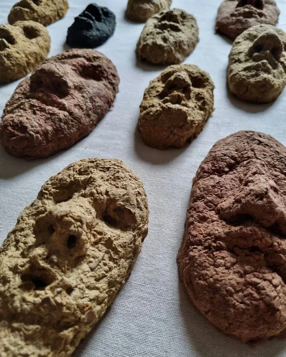 Set of unique handmade textured papier mache faces in earthy tones. Unknown age.  Unknown artist.