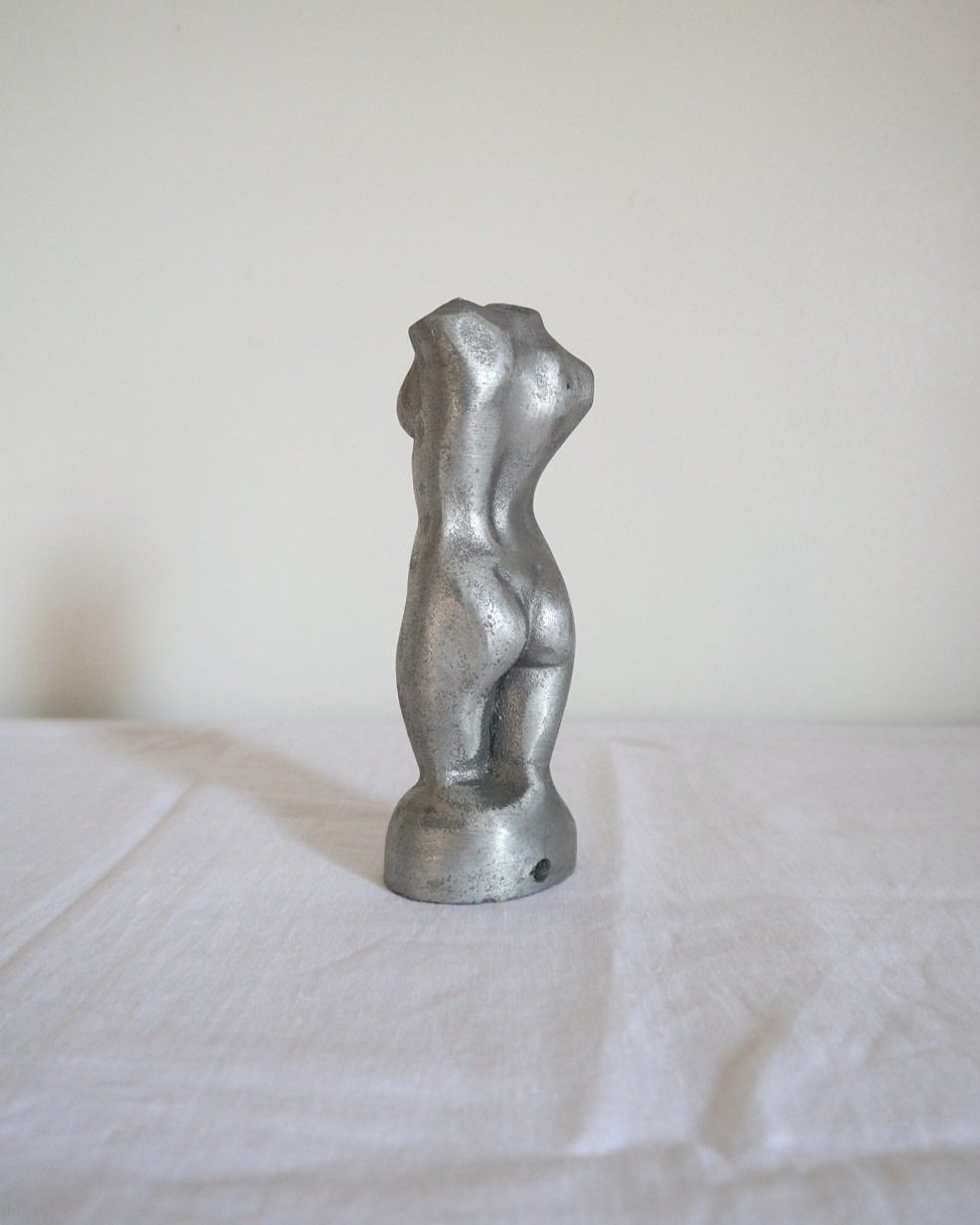 Modernist cast aluminium naked torso sculpture.