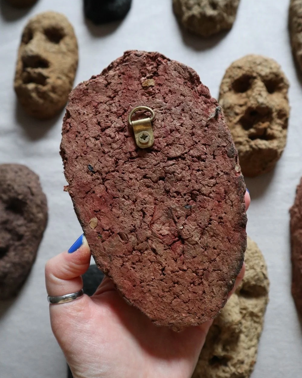 Set of unique handmade textured papier mache faces in earthy tones. Unknown age.  Unknown artist.