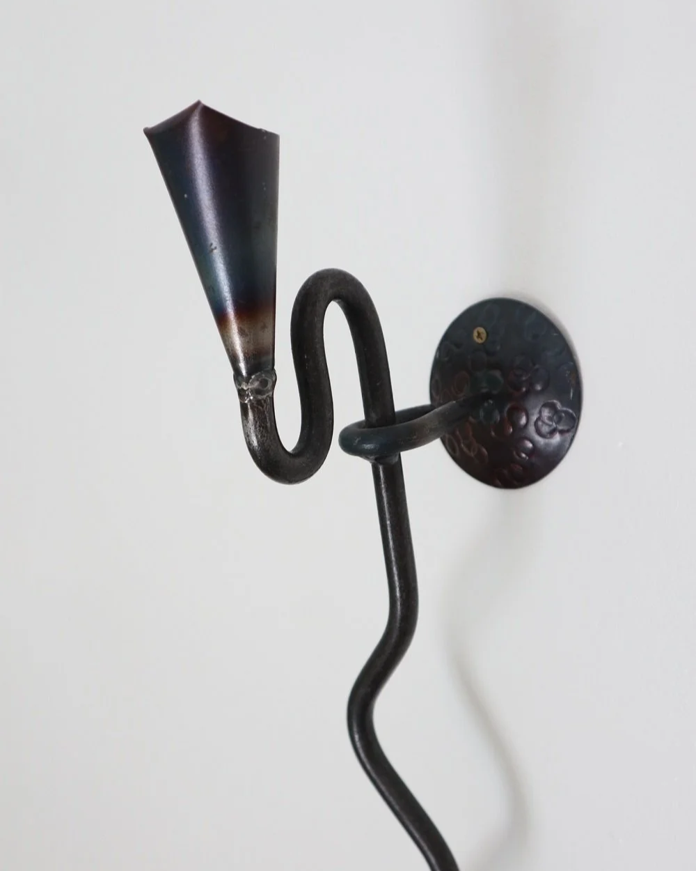 Large Swedish black iron wall sconce candleholder with wavy design. Circa 1960s.