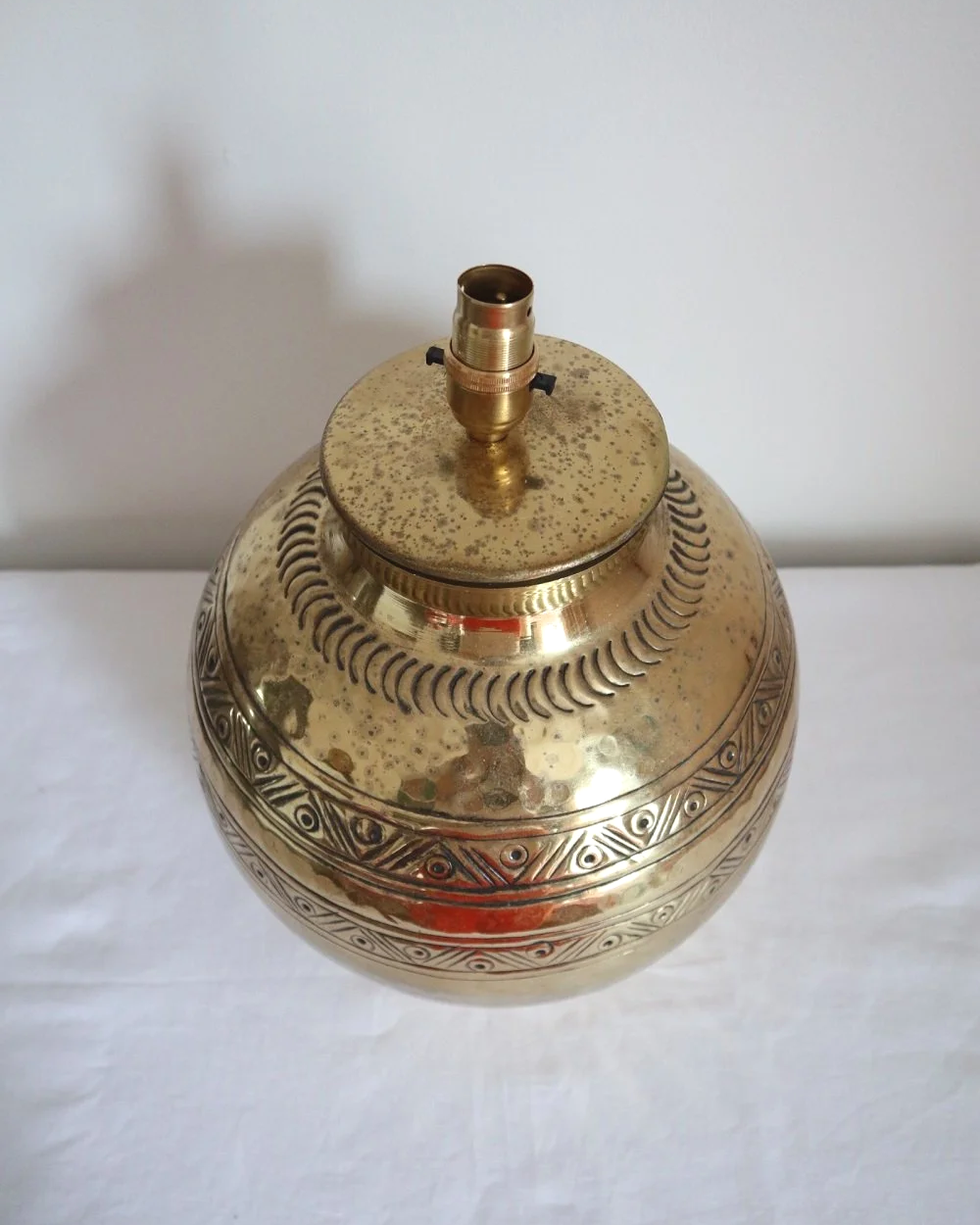 Pair of large, vintage beaten brass spherical table lamps with etched decoration.