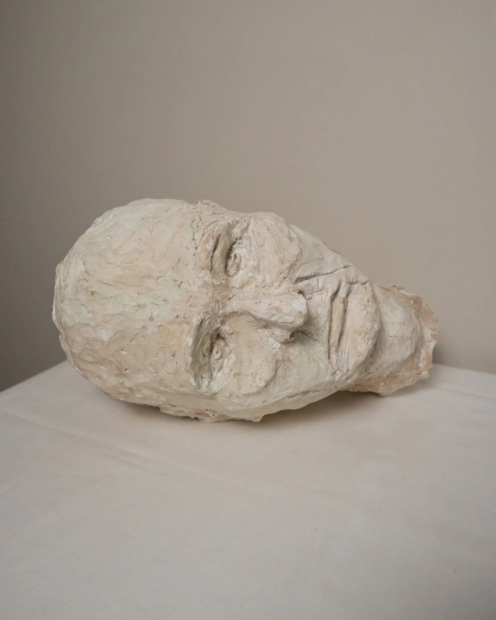 Large, heavy off white textured plaster sculpture of man's head in abstract style. Unknown age.