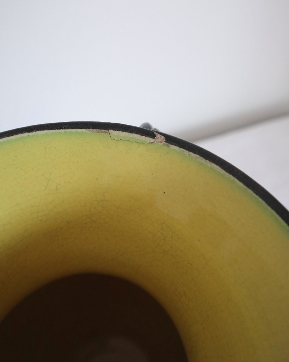 Large glossy, metallic black vase with double twisted handles and contrasting, yellow crackled glaze interior. Typical of Elchinger productions, France. Circa 1950s