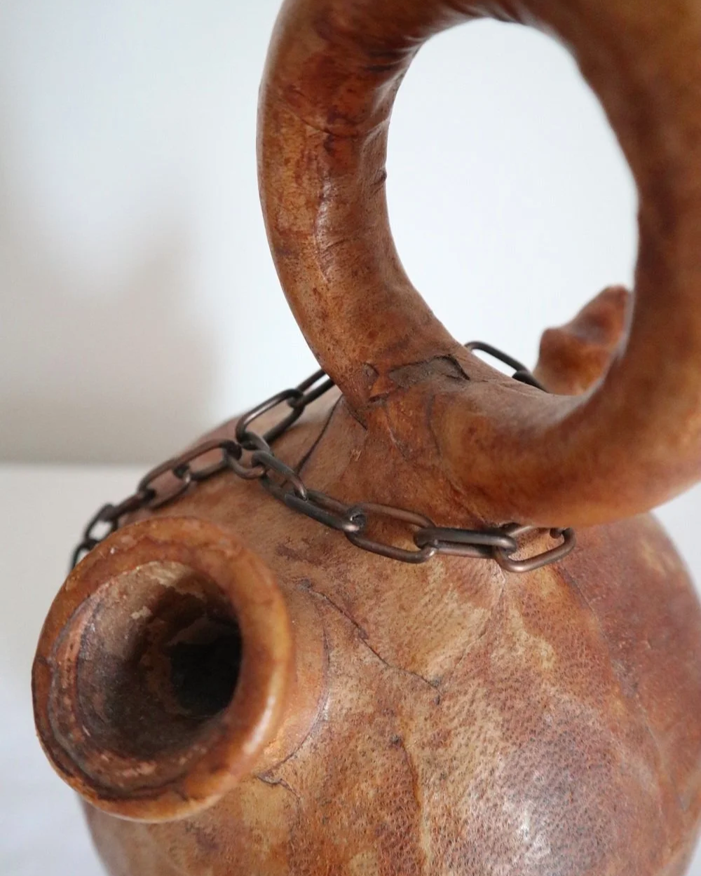Spanish distressed tan leather covered oil or water pourer.