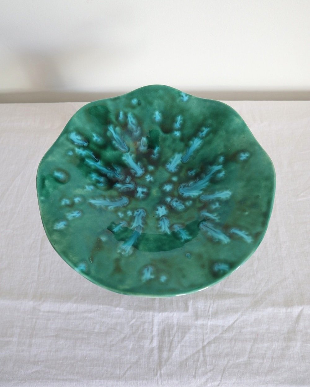 Studio pottery vibrant blue green shiny drip glaze pedestal cake stand / dish with wavy edge.