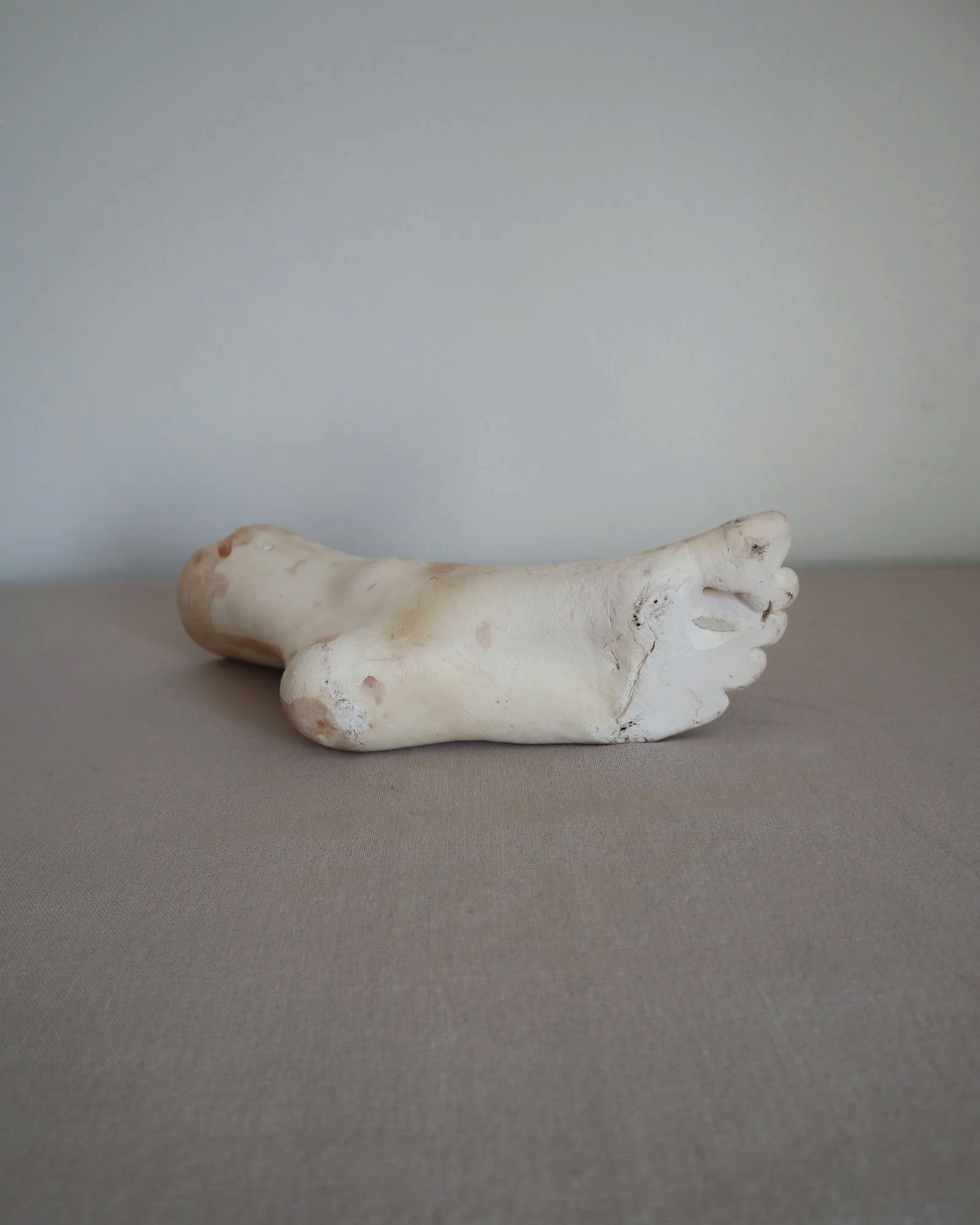 Classical-style decorative plaster foot sculpture, likely used as an anatomical or art studio study model.