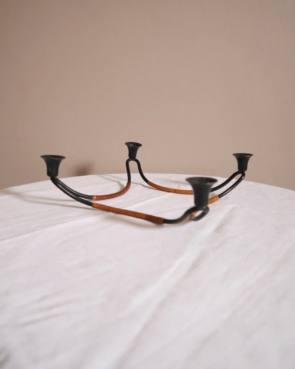 Modernist Danish iron and woven rattan four candle holder designed by Laurids Lønborg. Circa 1950s.