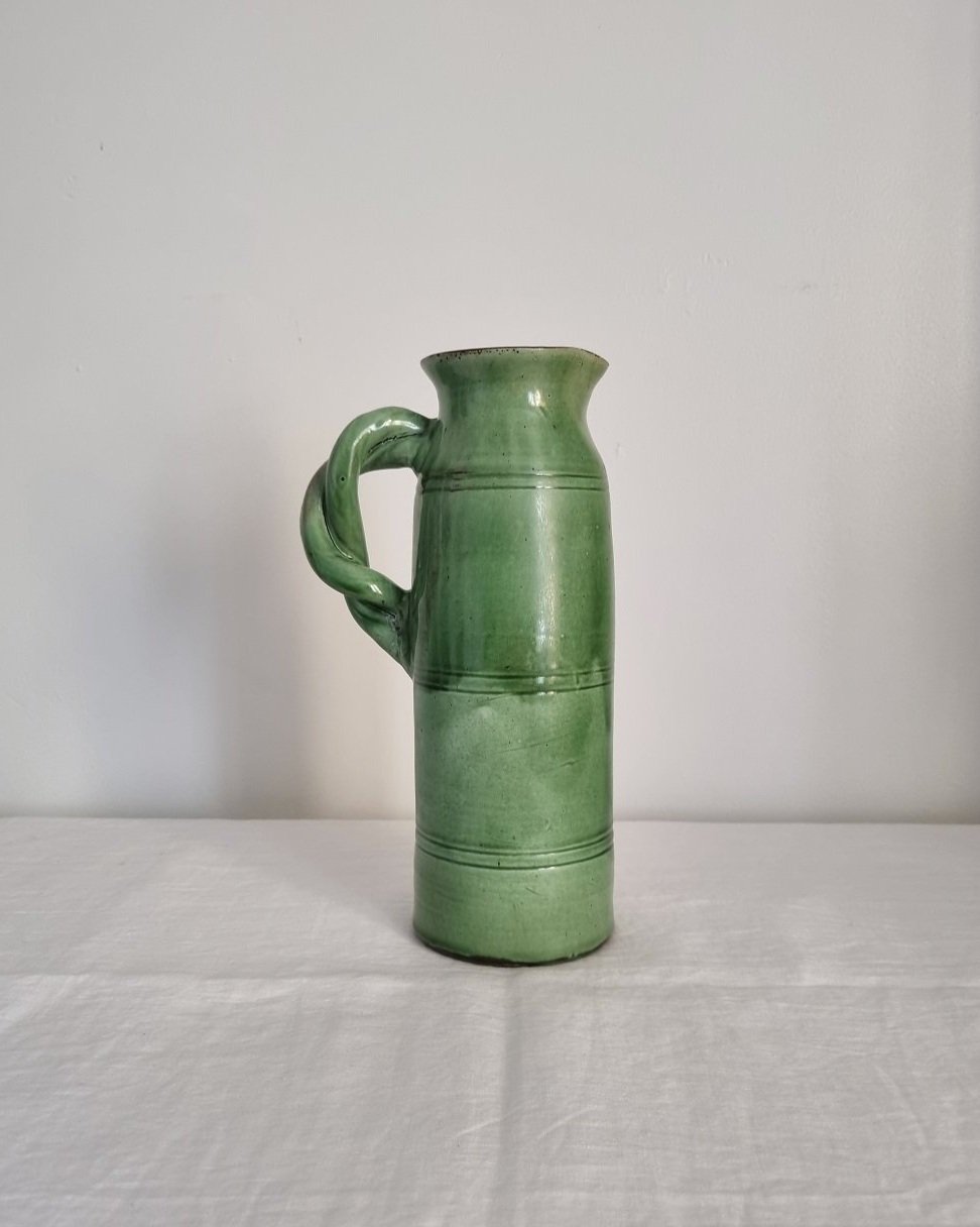 Tall studio pottery leaf green glazed water pitcher jug with twisted handle and banded centre. Marked Schofield Penrith.