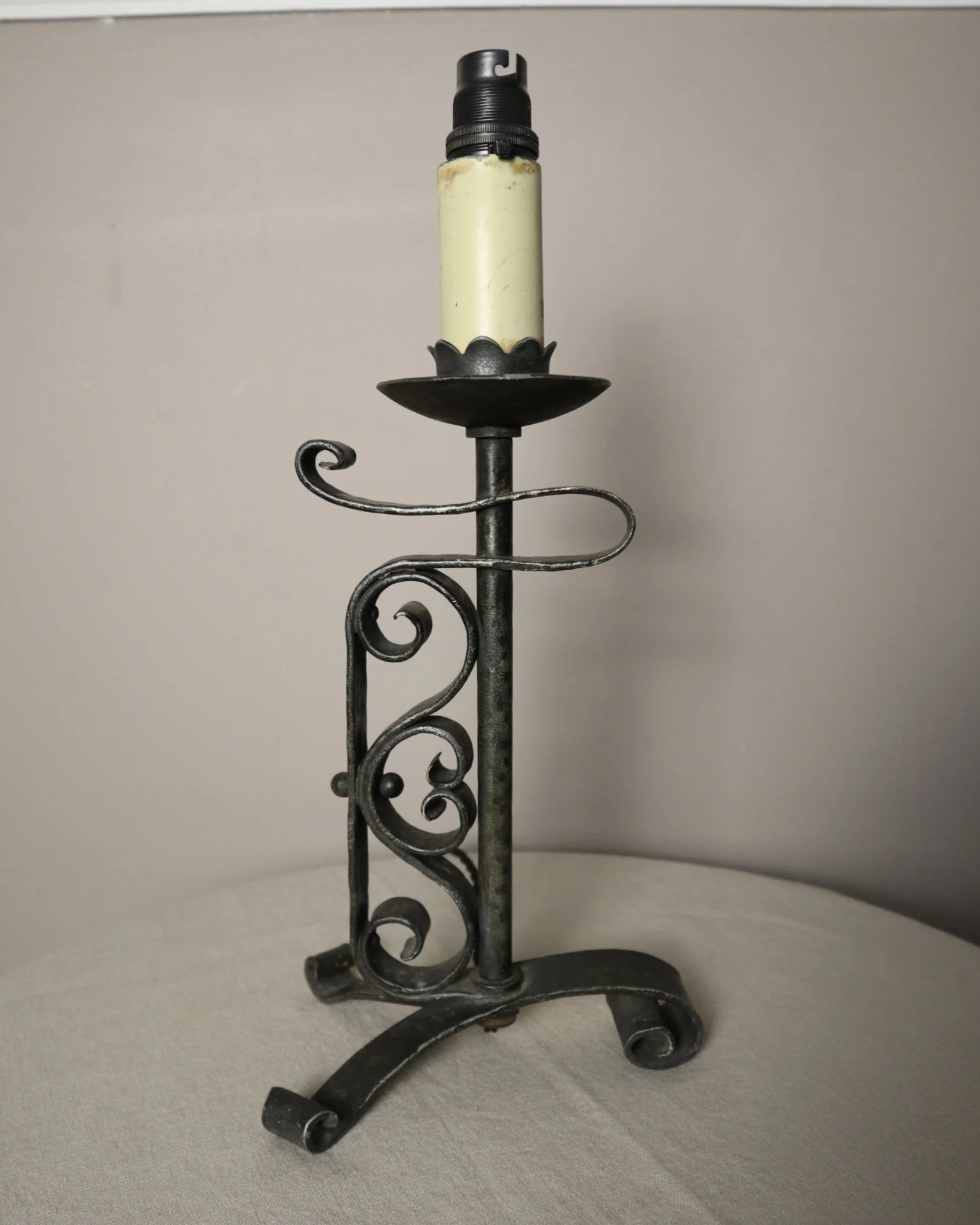 Vintage Art Deco style metal candlestick table lamp with elegant scroll detailing.