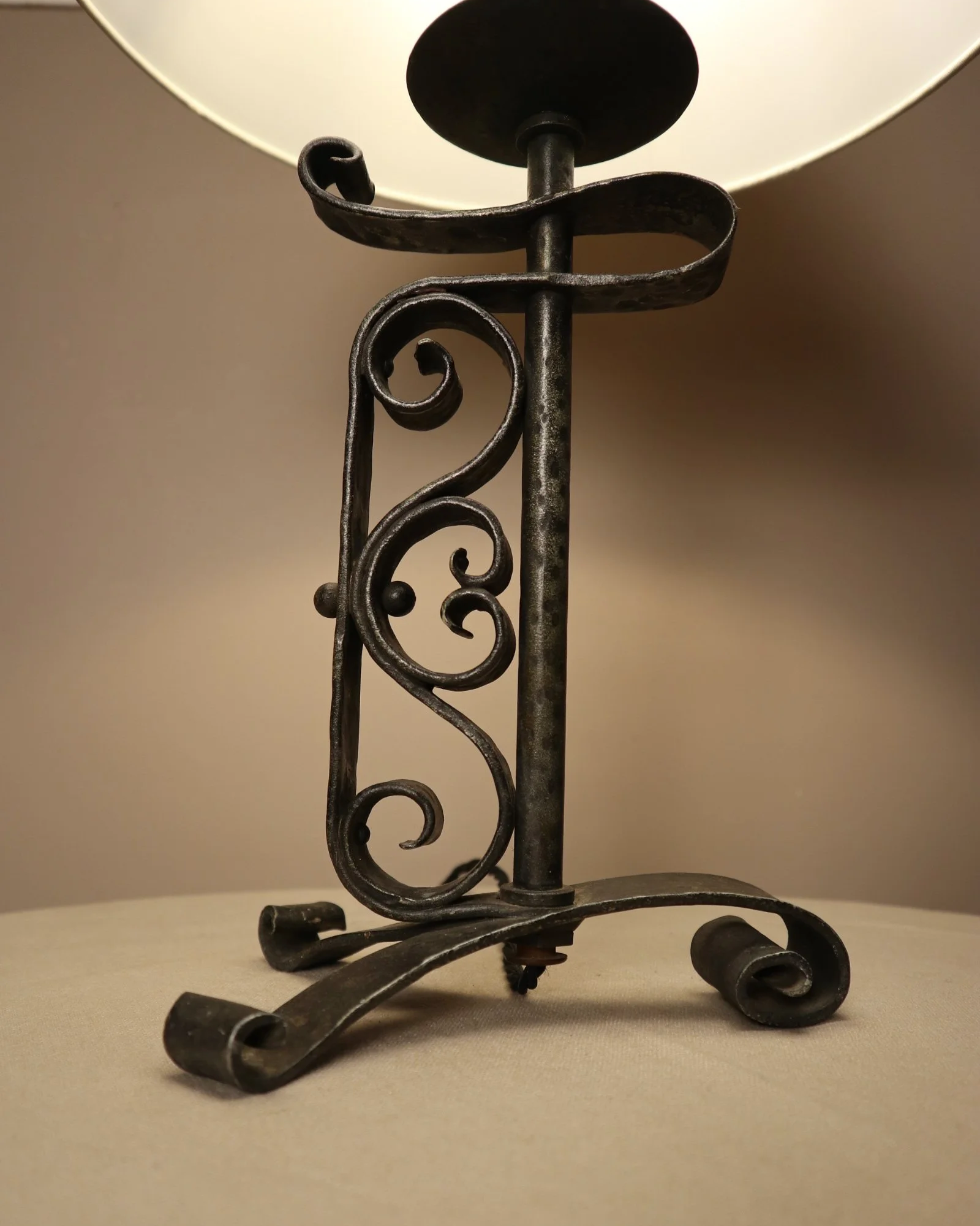 Vintage Art Deco style metal candlestick table lamp with elegant scroll detailing.